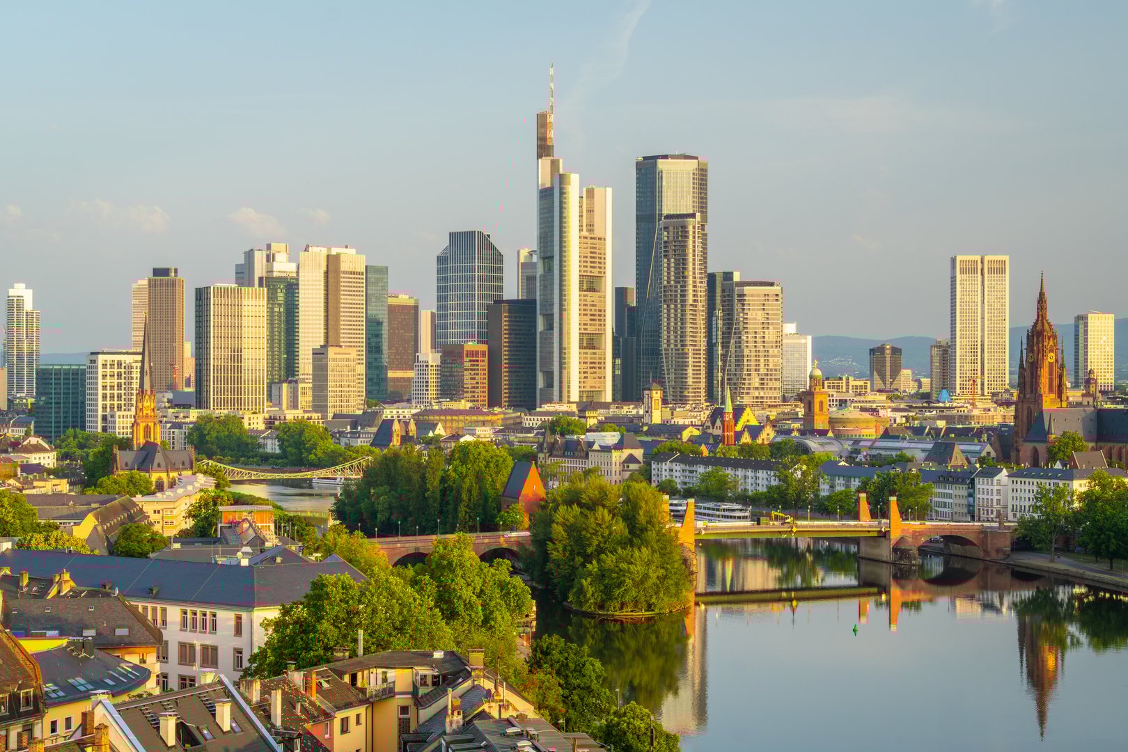 Frankfurt City Skyline, Residential Buildings, Bridges and Main River on Sunny Morning. Aerial View. Golden Hour. Hesse, Germany