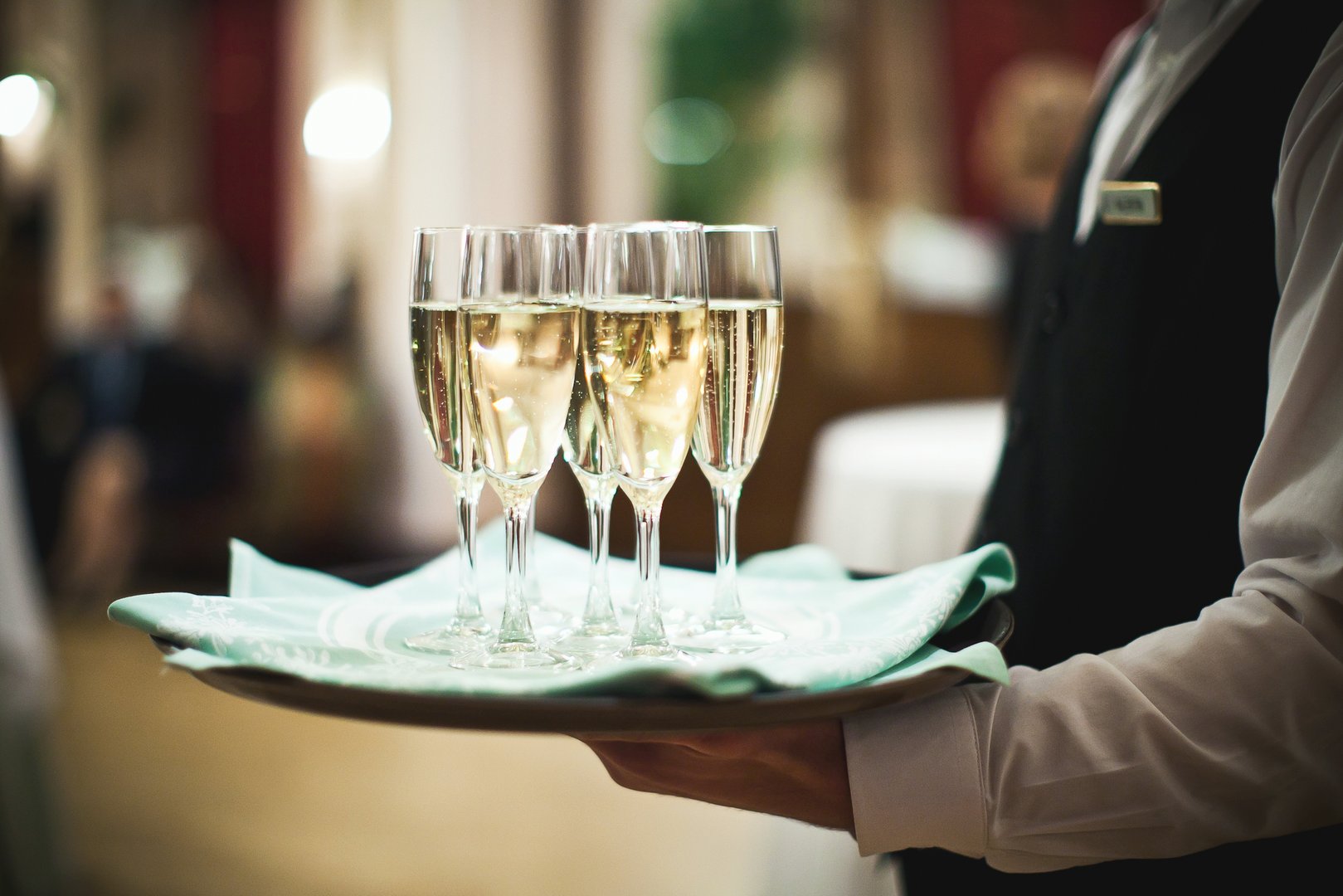 Waiter serving champagne on a tray
