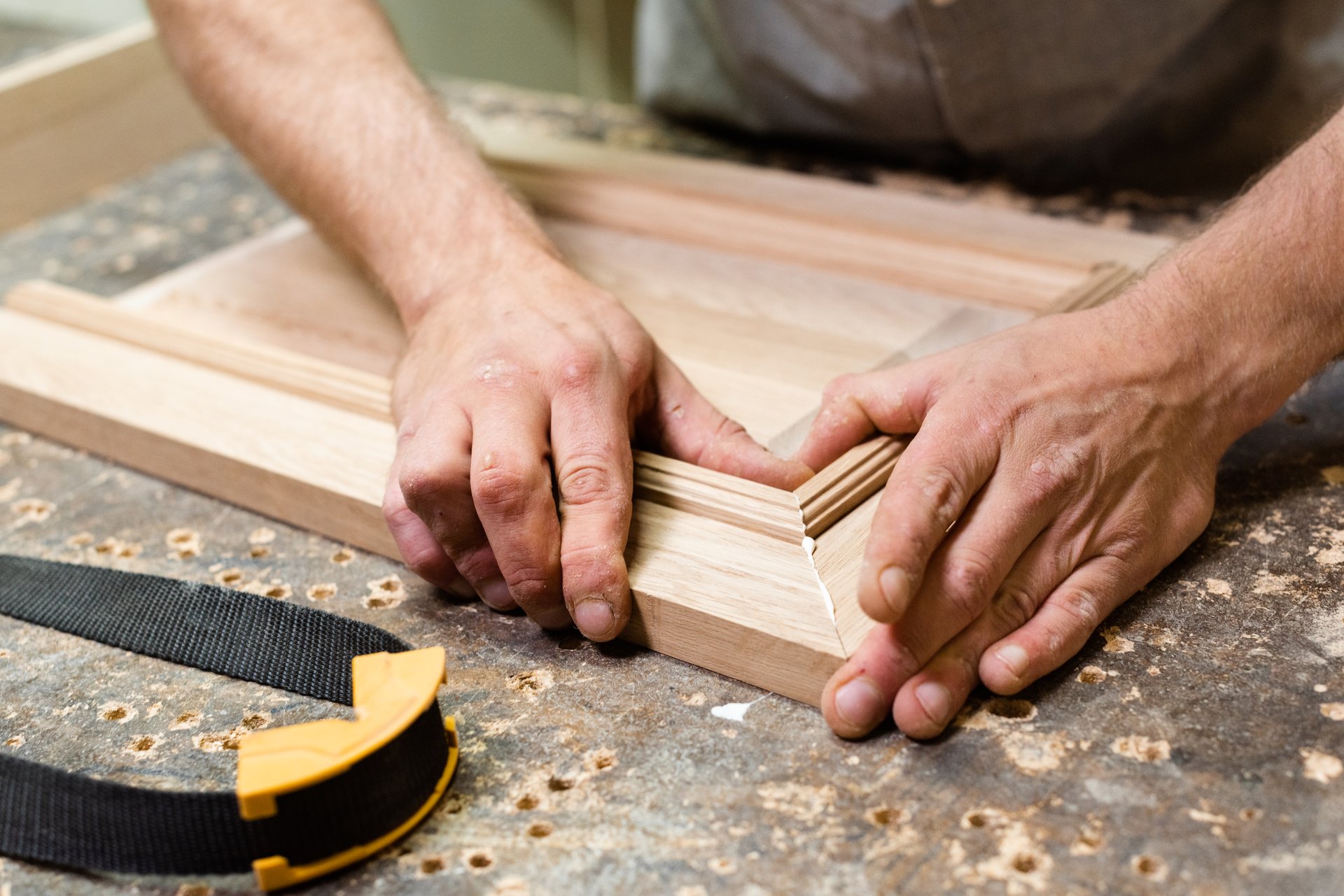 The carpenter combines the parts for gluing closeup