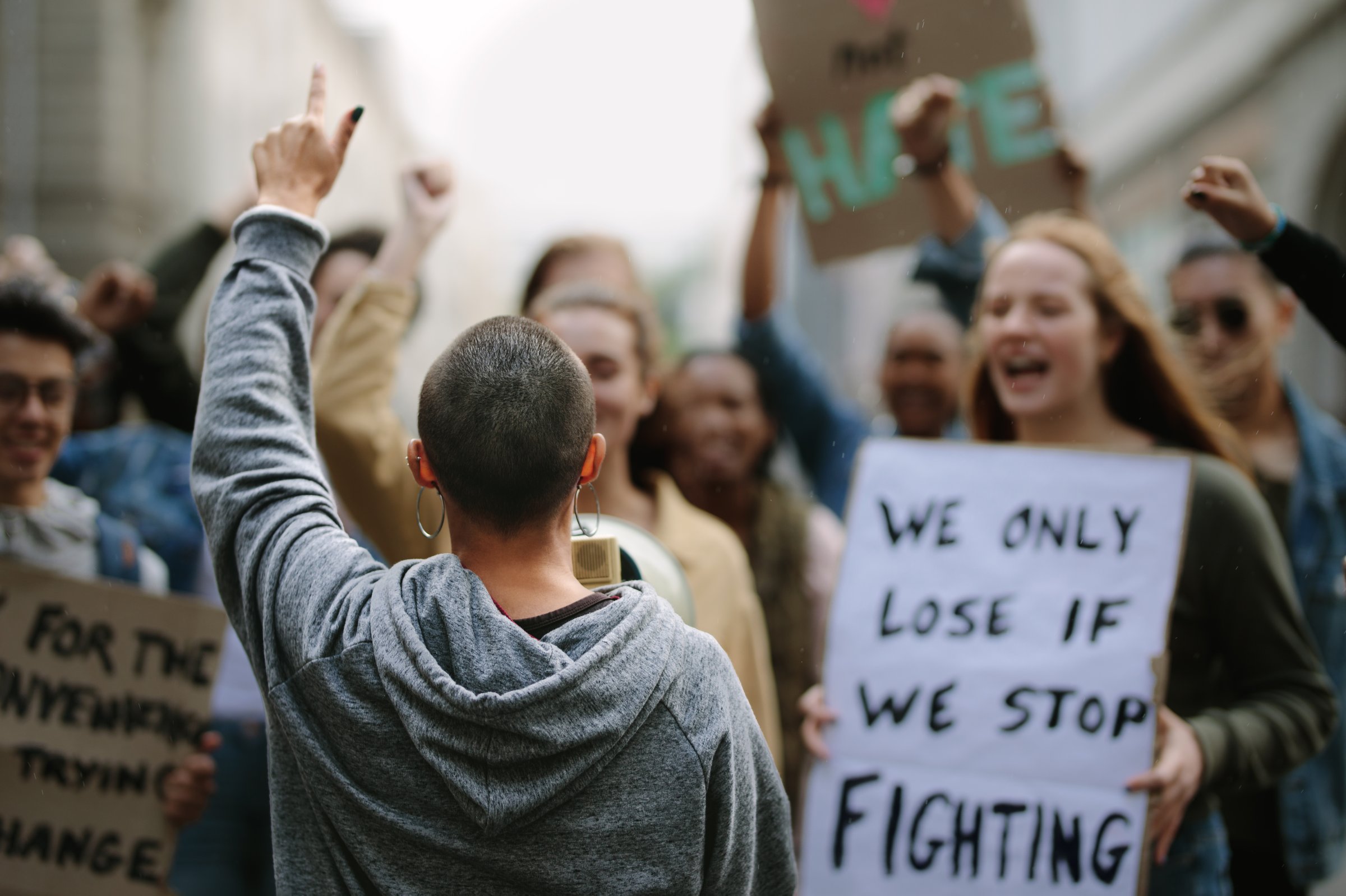 Female activist shouting on a megaphone in a protest march