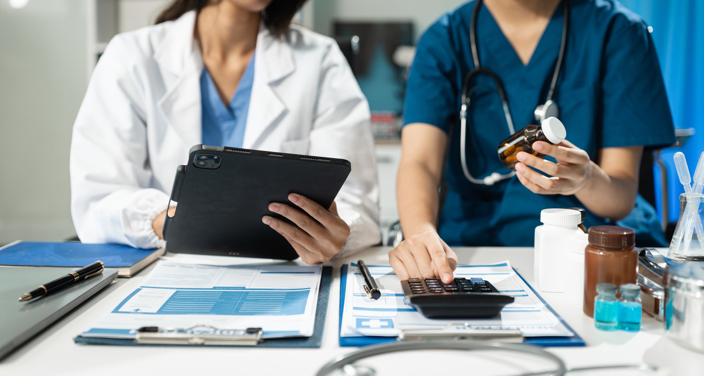 Doctors use a service fee calculator to save money on health insurance, drug cost concepts.