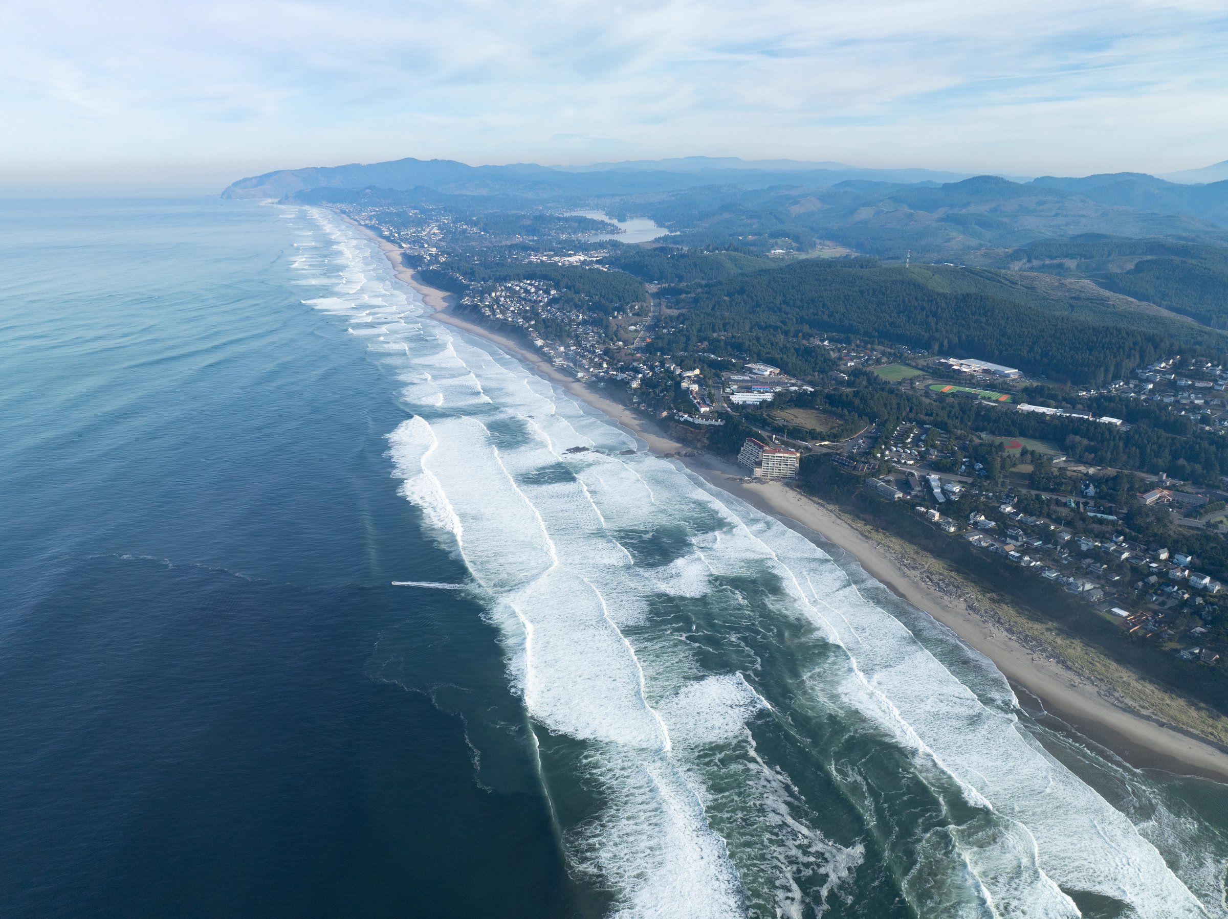 The Pacific Ocean washes against the extensive. beach along Lincoln City, Oregon. This part of the Pacific Northwest coast is incredibly scenic and accessed from highway 101.