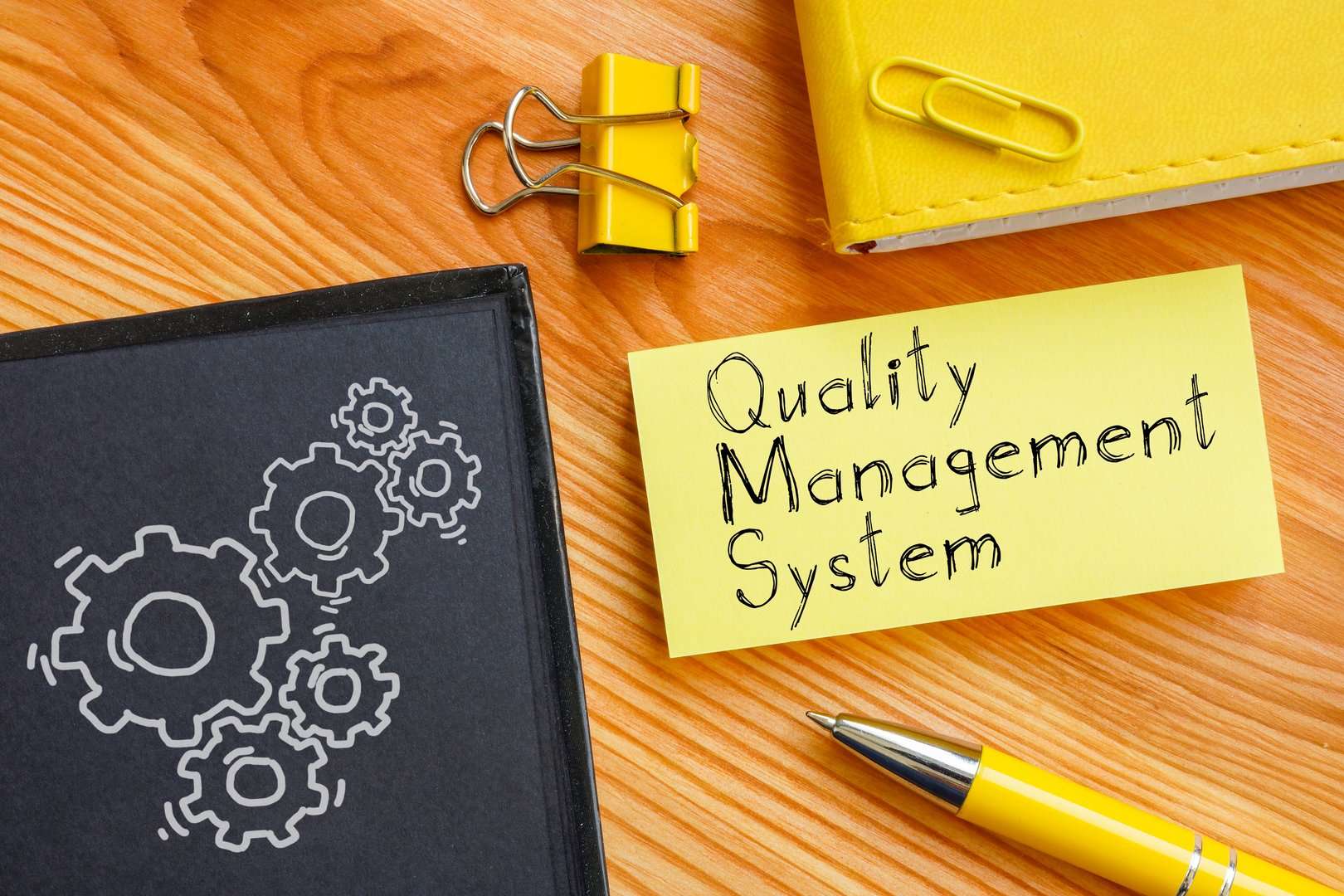 Quality management system is shown on a business photo using the text