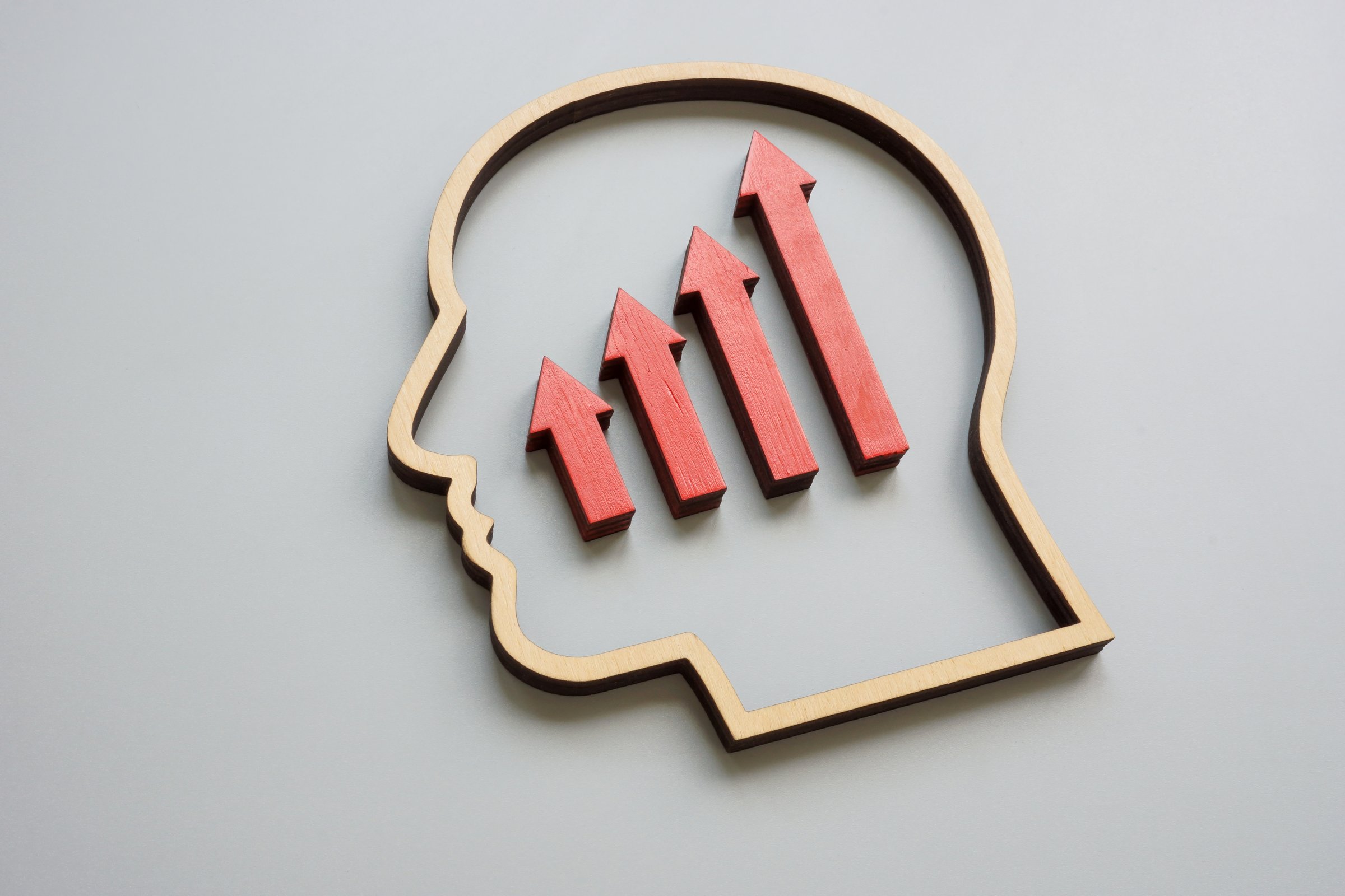 A head outline and growing arrows. Concept of training and upskilling.