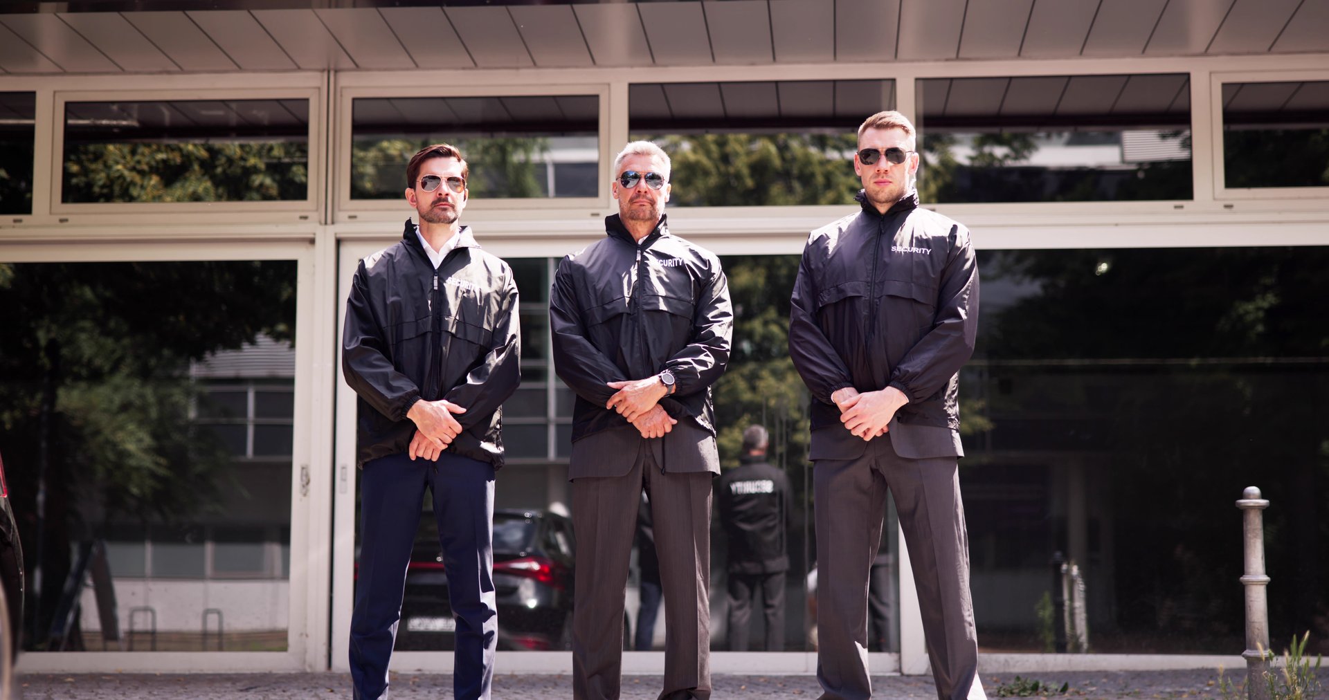Professional security guard overseeing event safety with his team of bodyguards and surveillance robots outdoors. Protecting people with expertise.