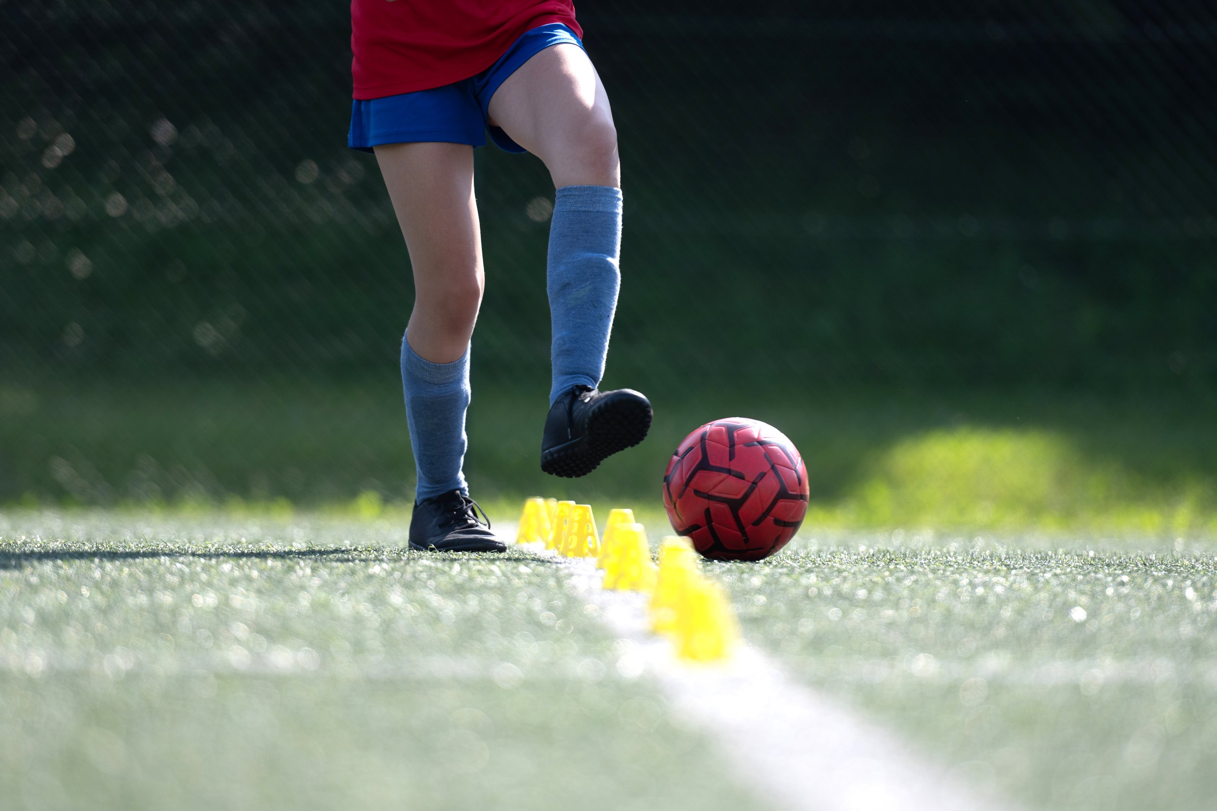 Girl dribbling ball in practice