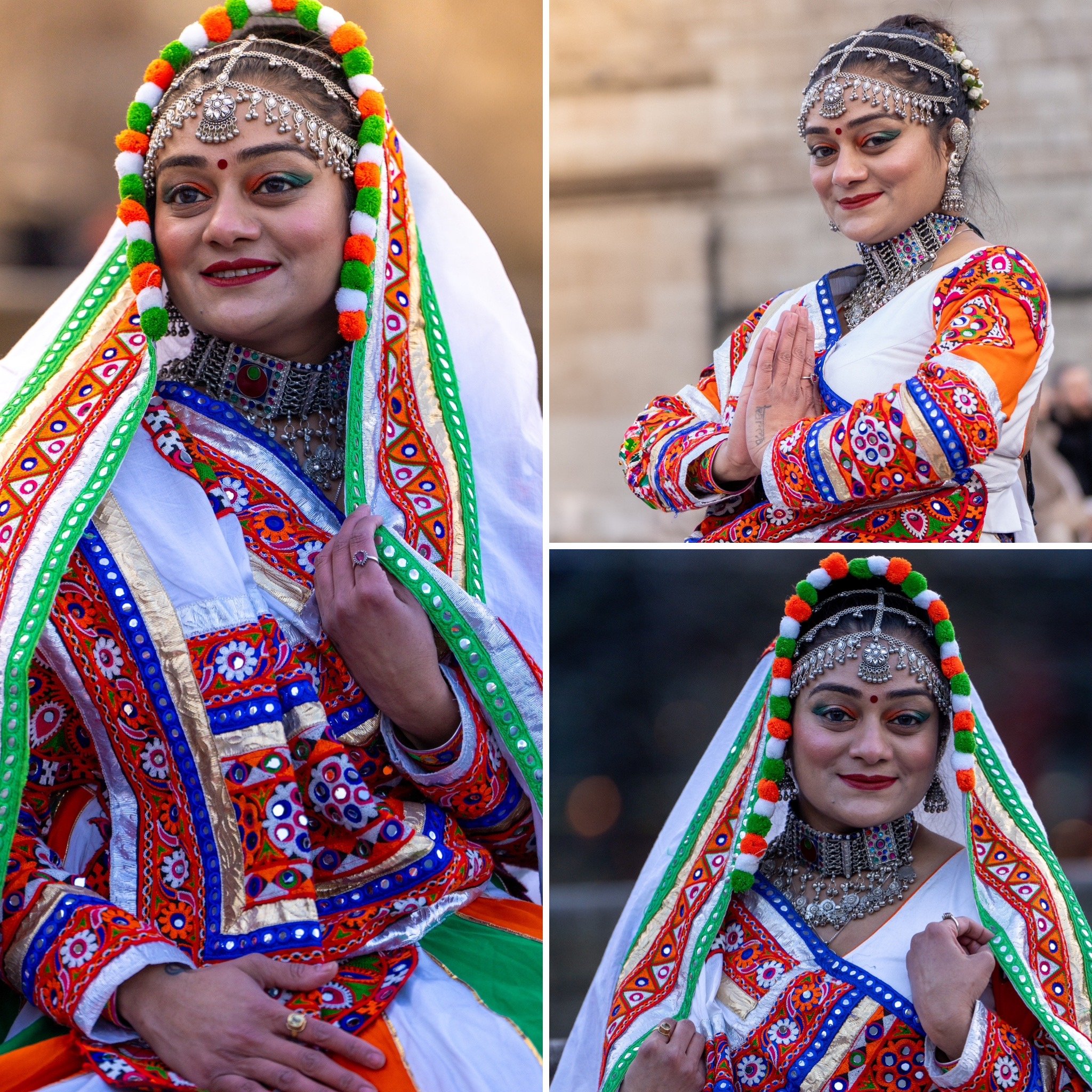 Woman in traditional colorful Indian attire, with intricate jewelry and vibrant patterns, posing with graceful hand gestures.