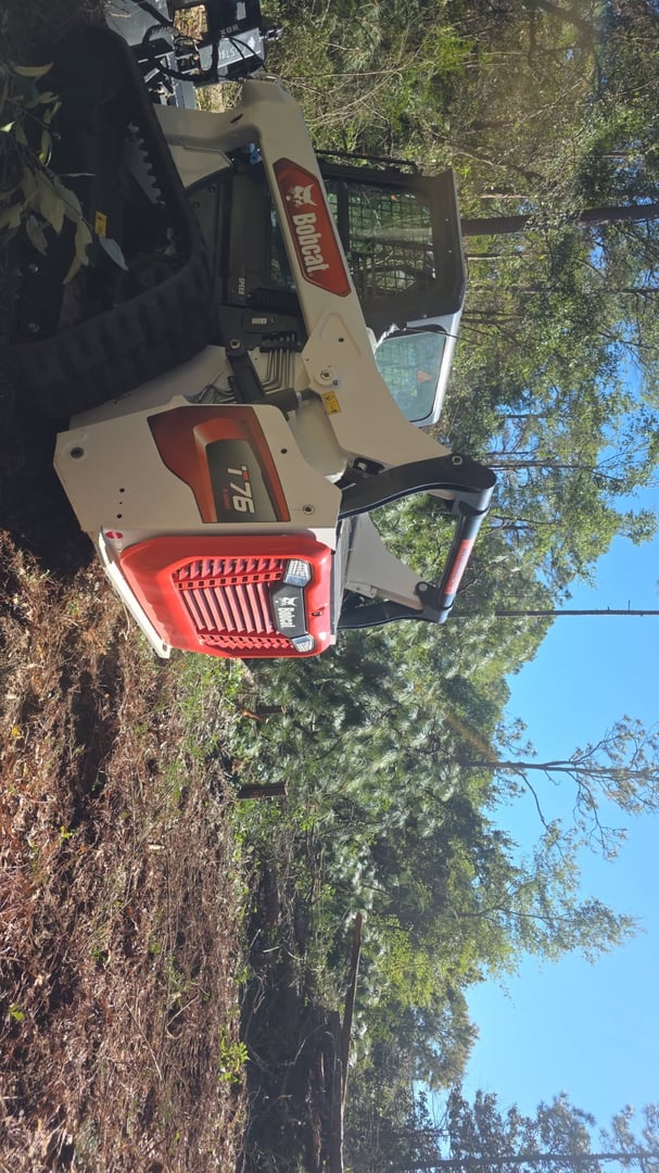 Land clearing equipment working on residential property