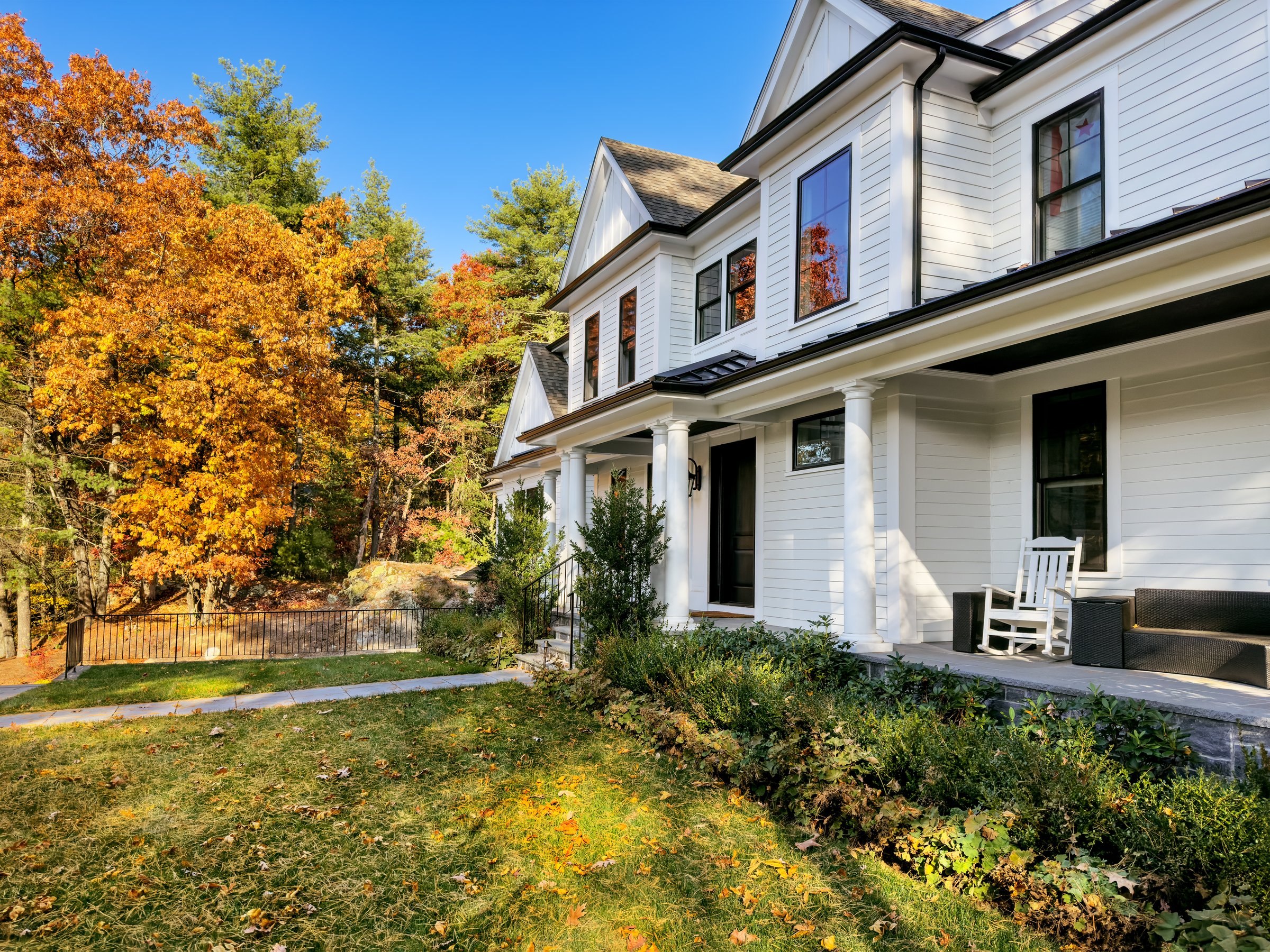 Autum colors plus leaves & pine needles on the lawn signal a fall afternoon in New England