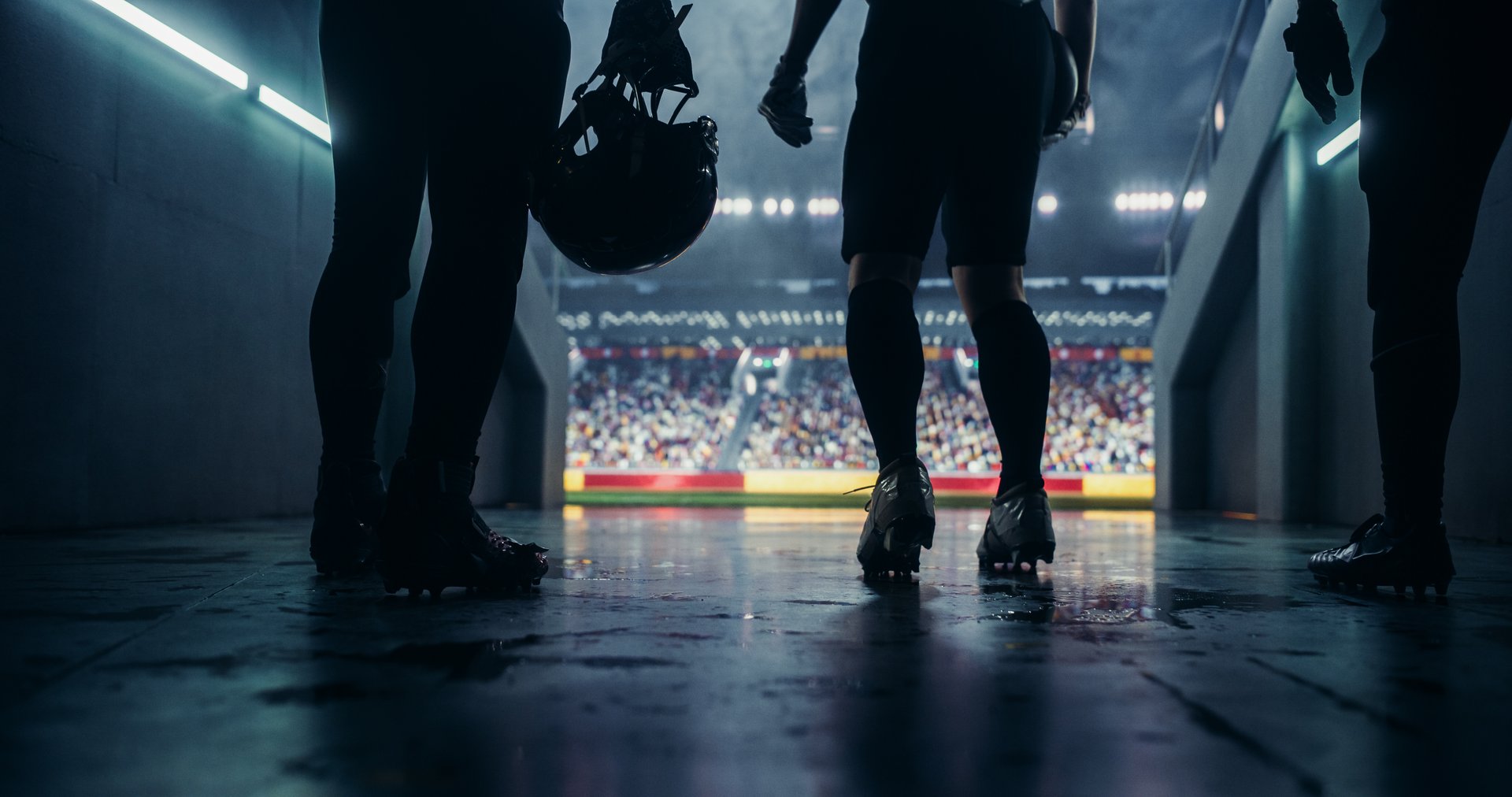 American Football Players Walk Out of Stadium Tunnel to Play a Championship Game. Enthusiastic Footballers Warming Up on Their Way Out. Excited Athletes Enter Field with Determination and Team Spirit