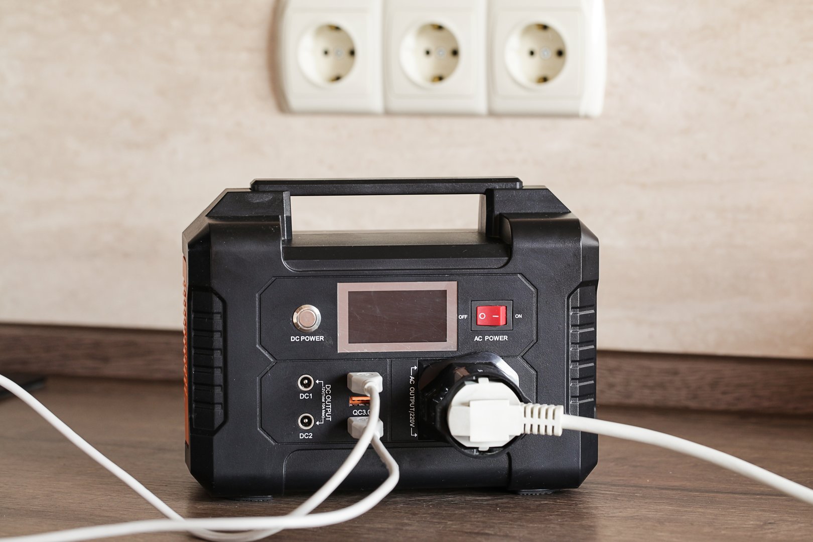 Portable Power Station and Multi-socket Extension Board with Chargers on table indoors