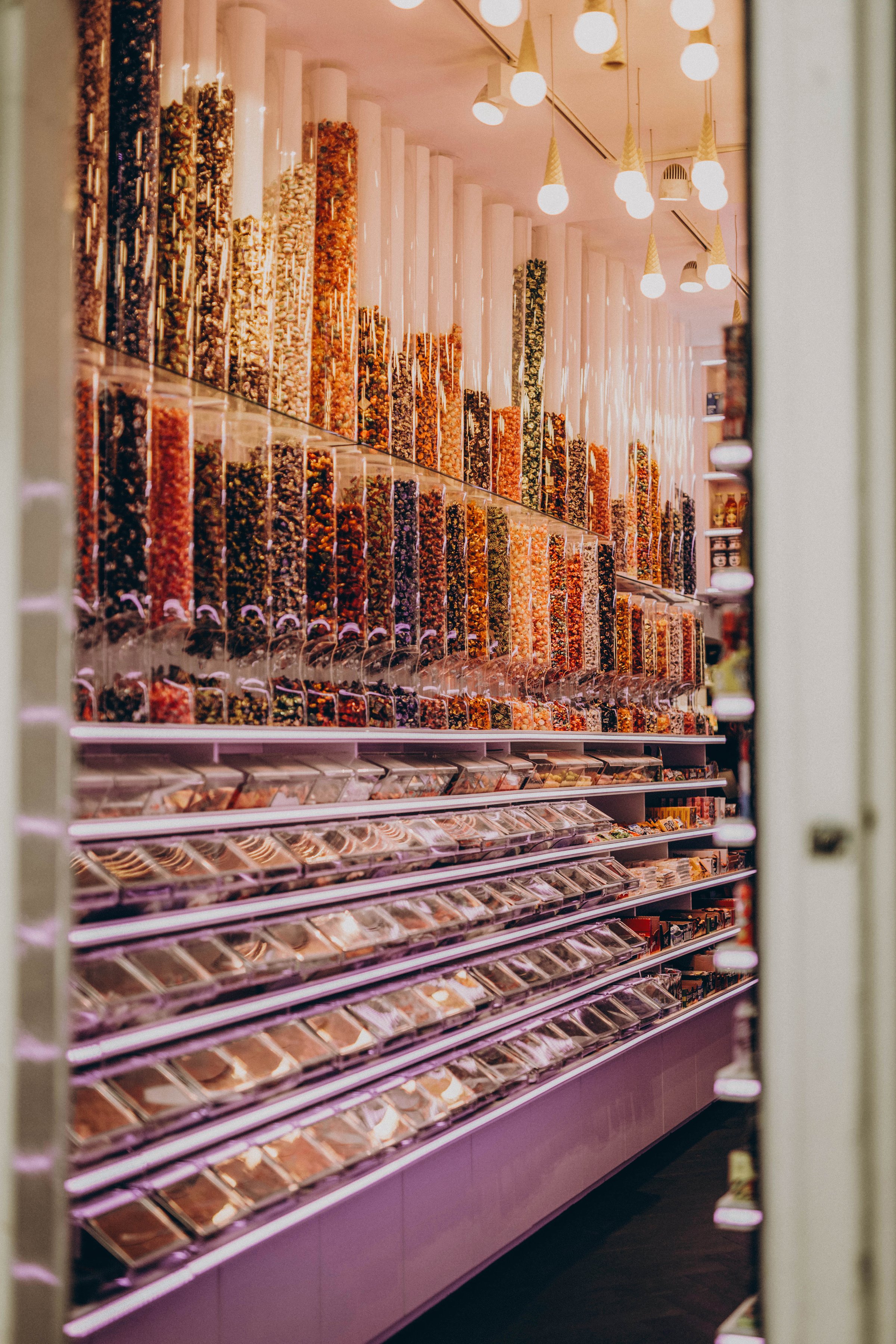 showcase of candy shop, transparent container with various sweets, marshmallow, jelly, chewy gums, . High quality photo