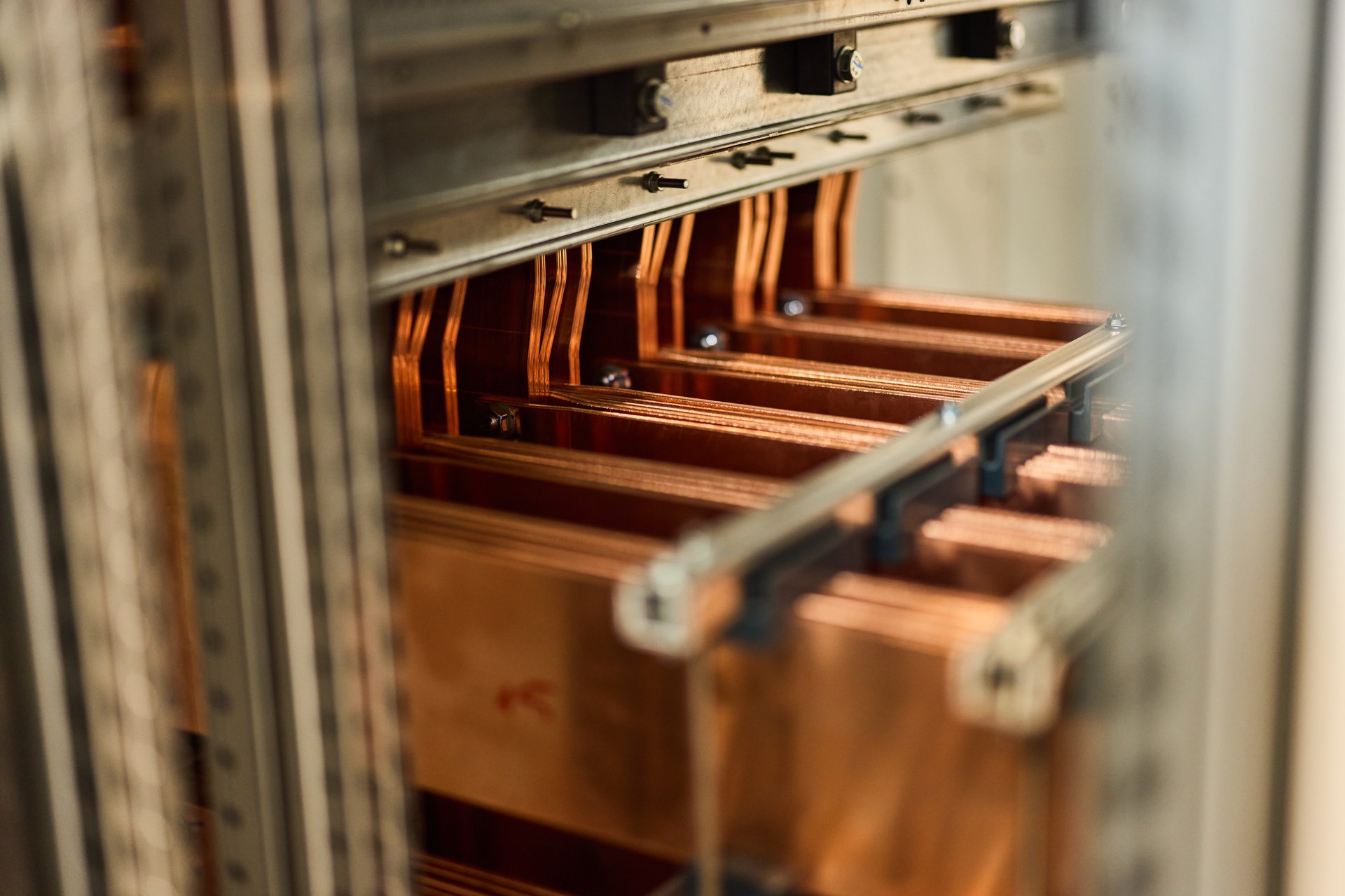 Detailed view of copper bars in electrical equipment, showcasing industrial and technological design.