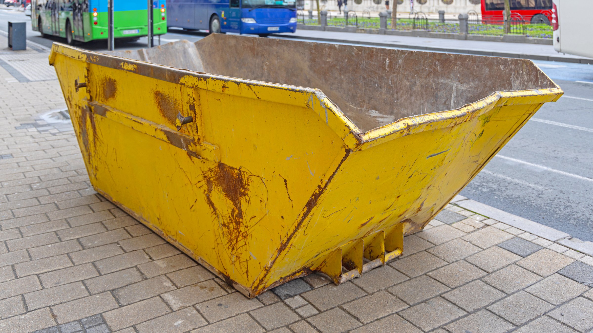 Empty Yellow Metal Skip Container at City Street