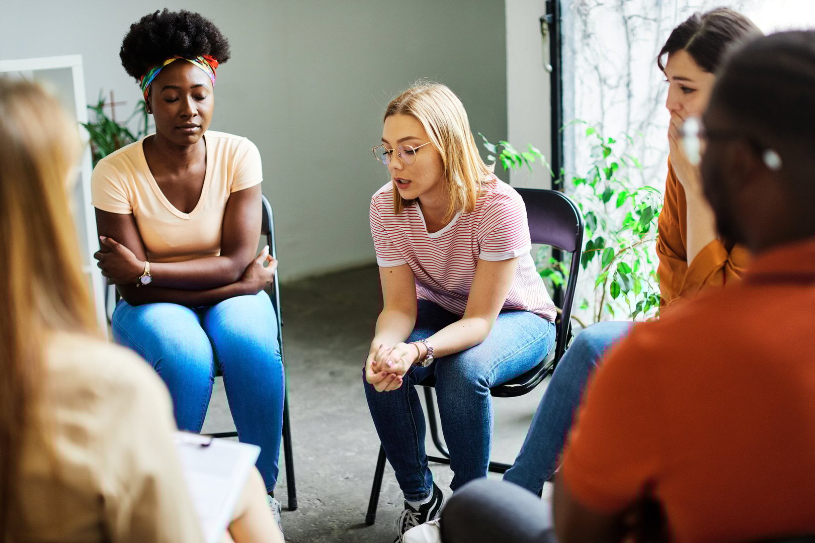 Group psychotherapy. Persons sitting in circle and talking. People meeting. Psychotherapy training, business lecture or conference. Man woman support group