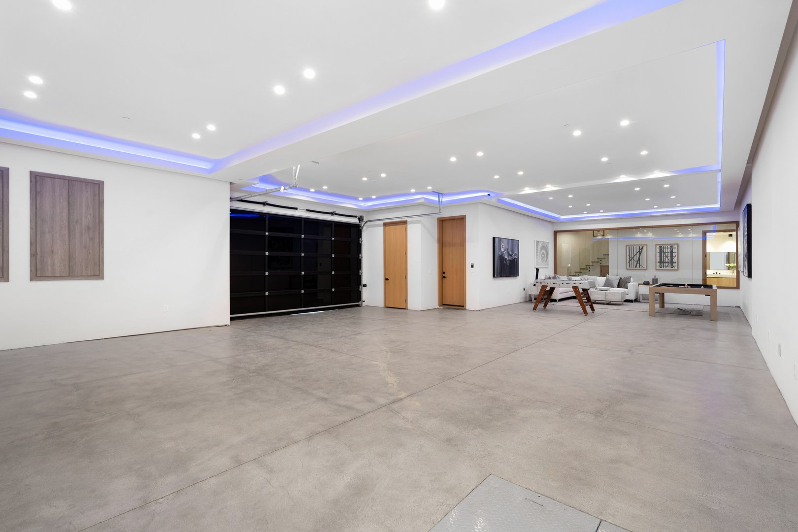 A modern room with open garage and white sofa.