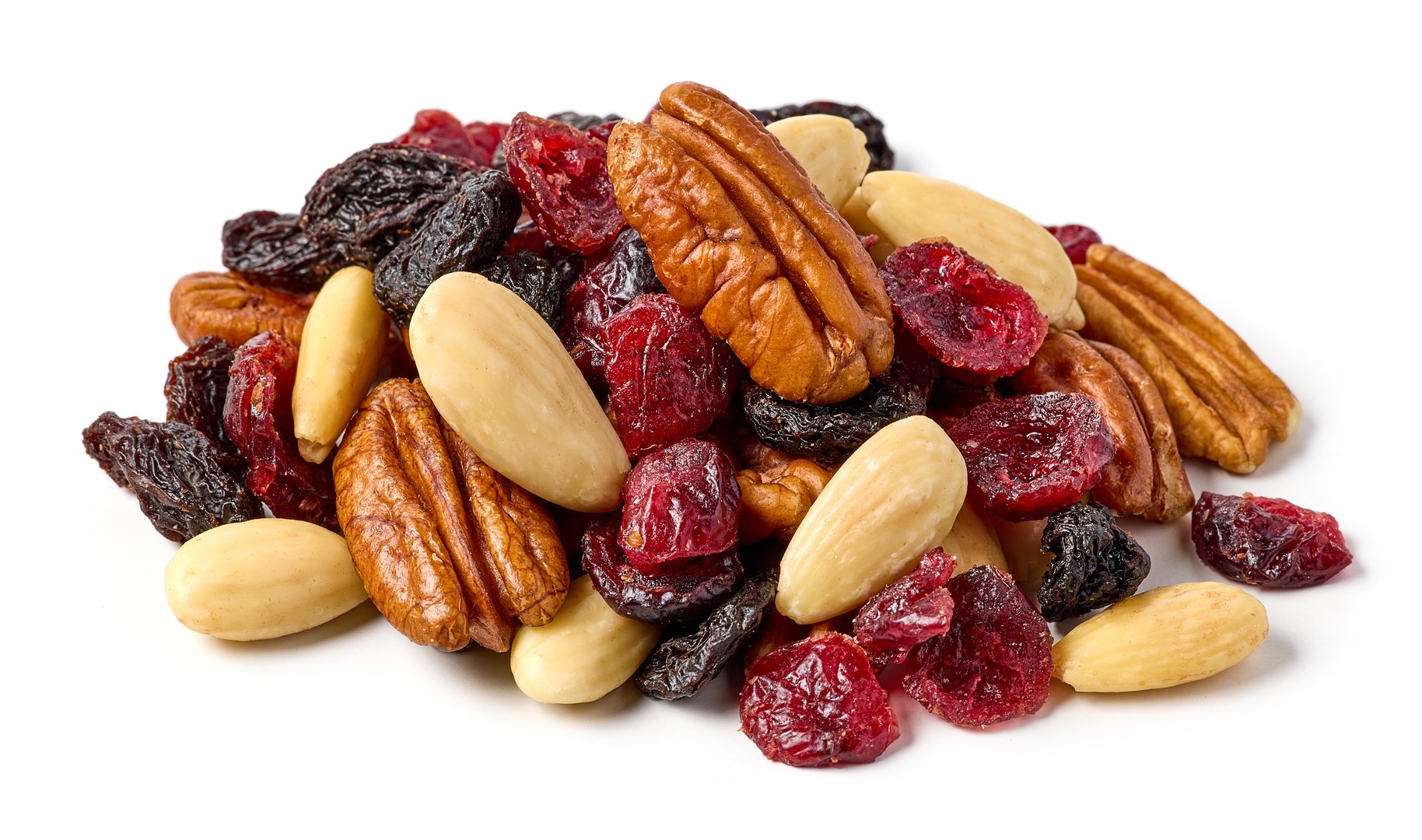 Mix of nuts and dry fruits isolated on a white background, almonds, walnuts, hazelnuts and raisins on a pile, healthy food