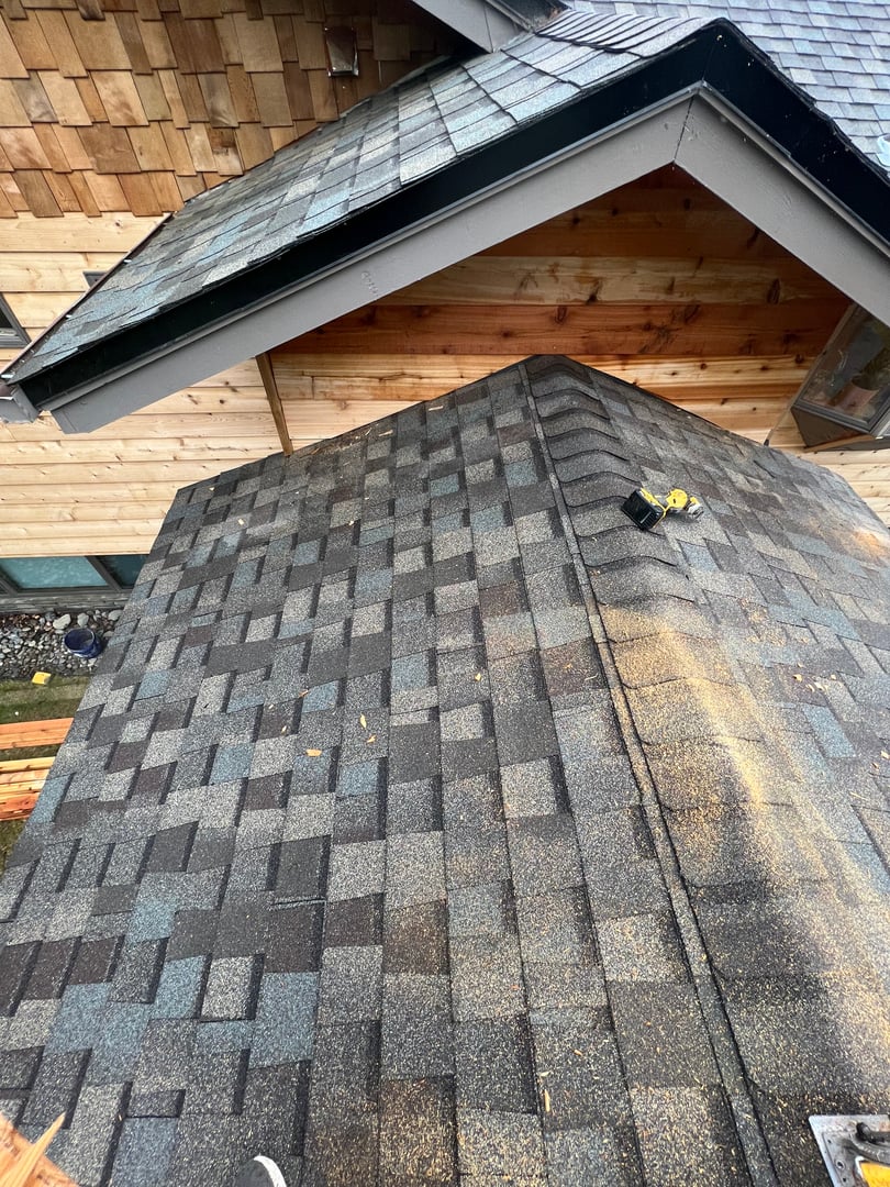 Professional roofing services Anchorage Alaska - shingle installation and roof repair on residential home showcasing quality workmanship by Northern Snow Removal