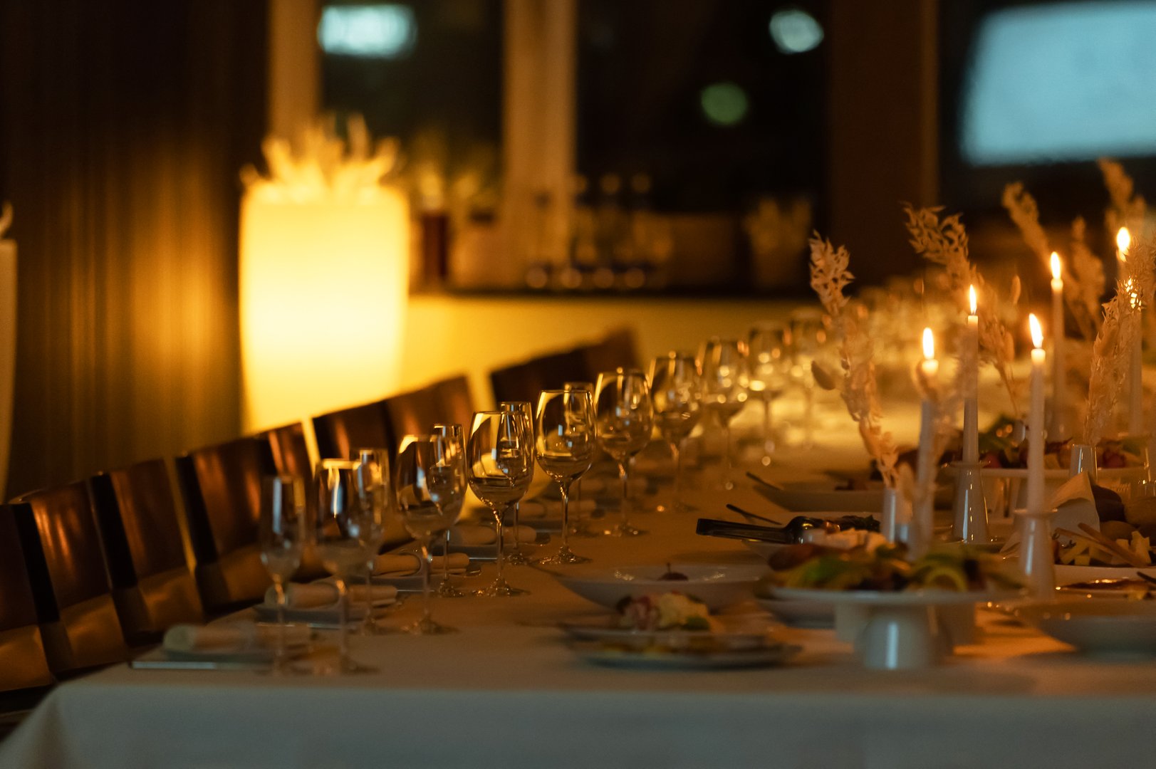 Festive dining table, winter holidays, dinner party and celebration concept - close up of Scandinavian Christmas table serving with burning candles at home at night