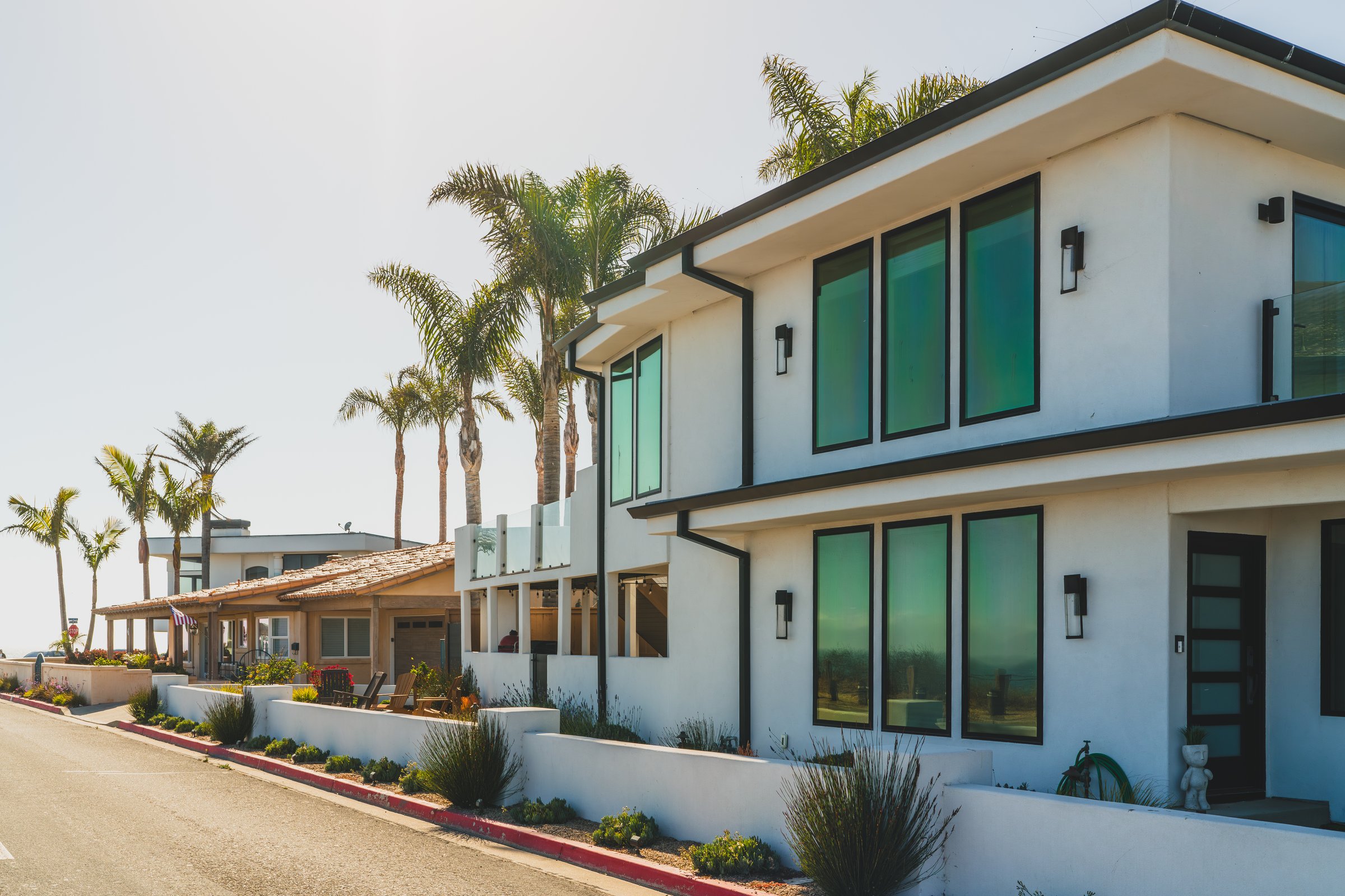 Contemporary coastal architecture lined with palm trees on a sunny day.Pismo Beach, California, USA, July 26, 2024