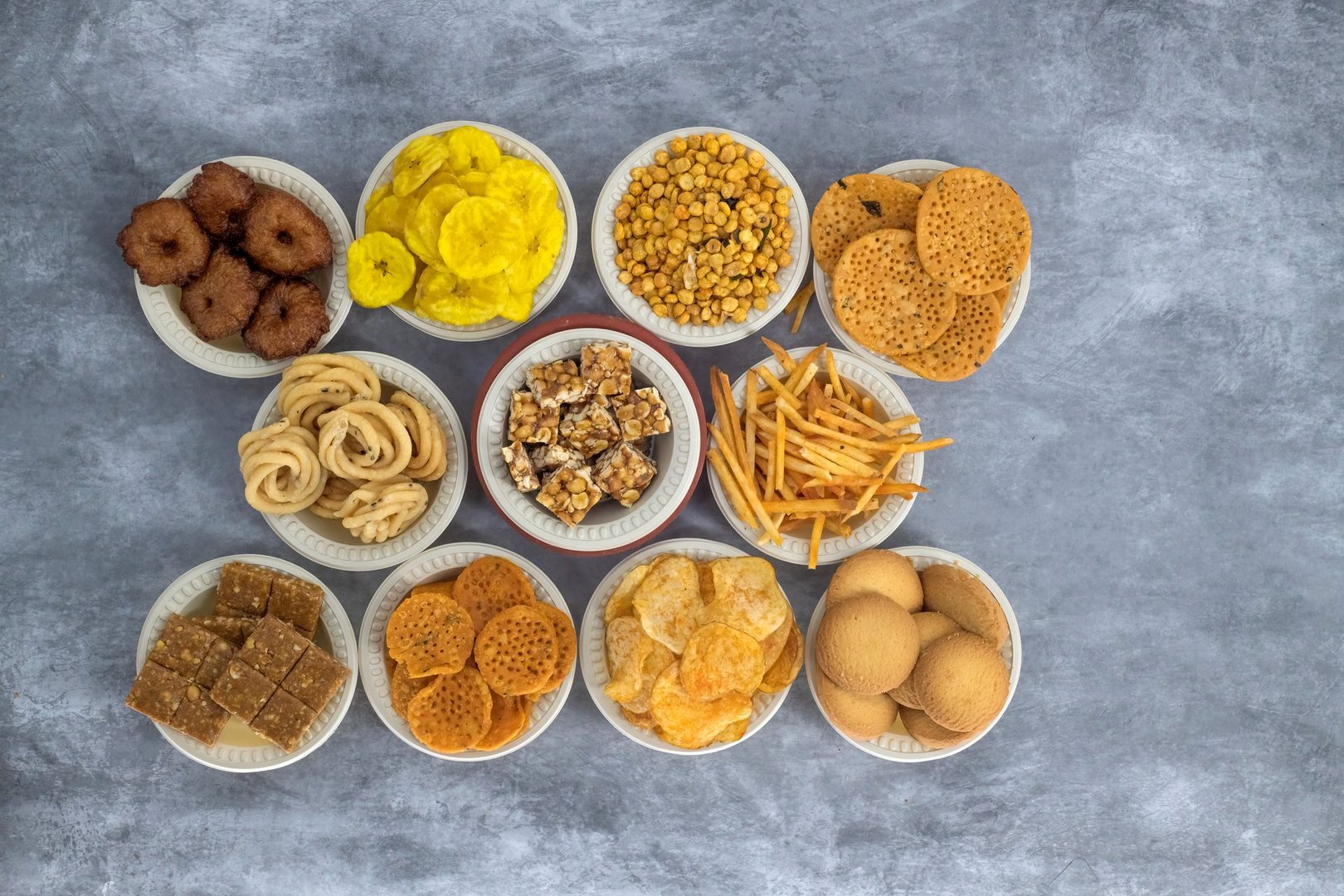 Selective focused Treditional Indian Diwali salty snacks and foods items and empty lamp on an isolated background. Tamilnadu snacks for the Diwali festival.