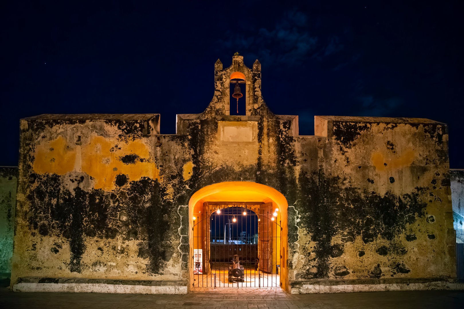Ancient hacienda gateway at night