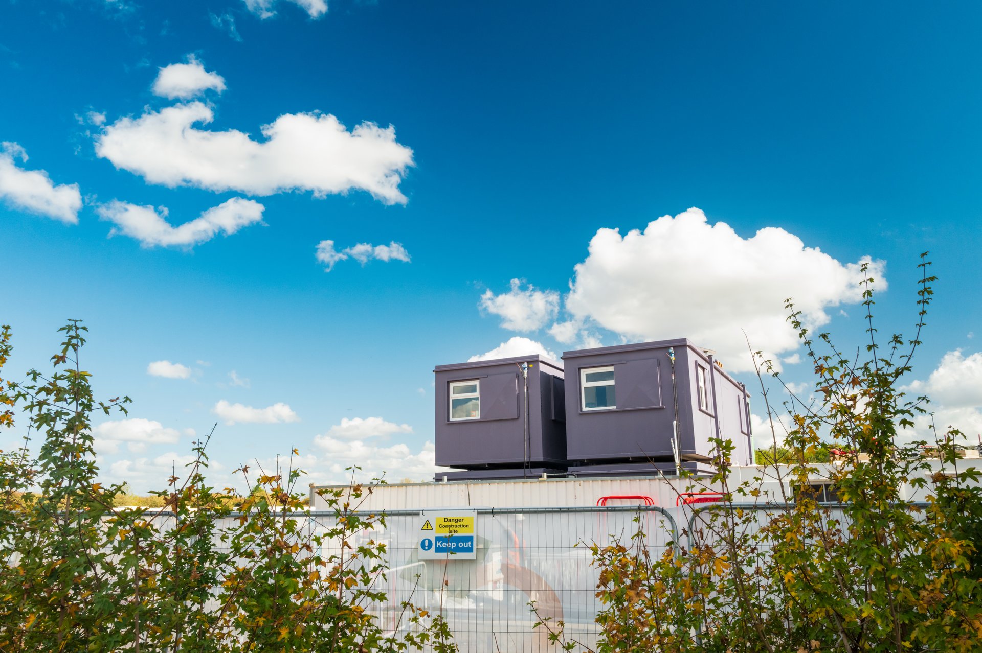 Two, temporary construction offices seen on a housing development site in the UK. The offices are staffed by architects and engineers for the housing development which is in progress.