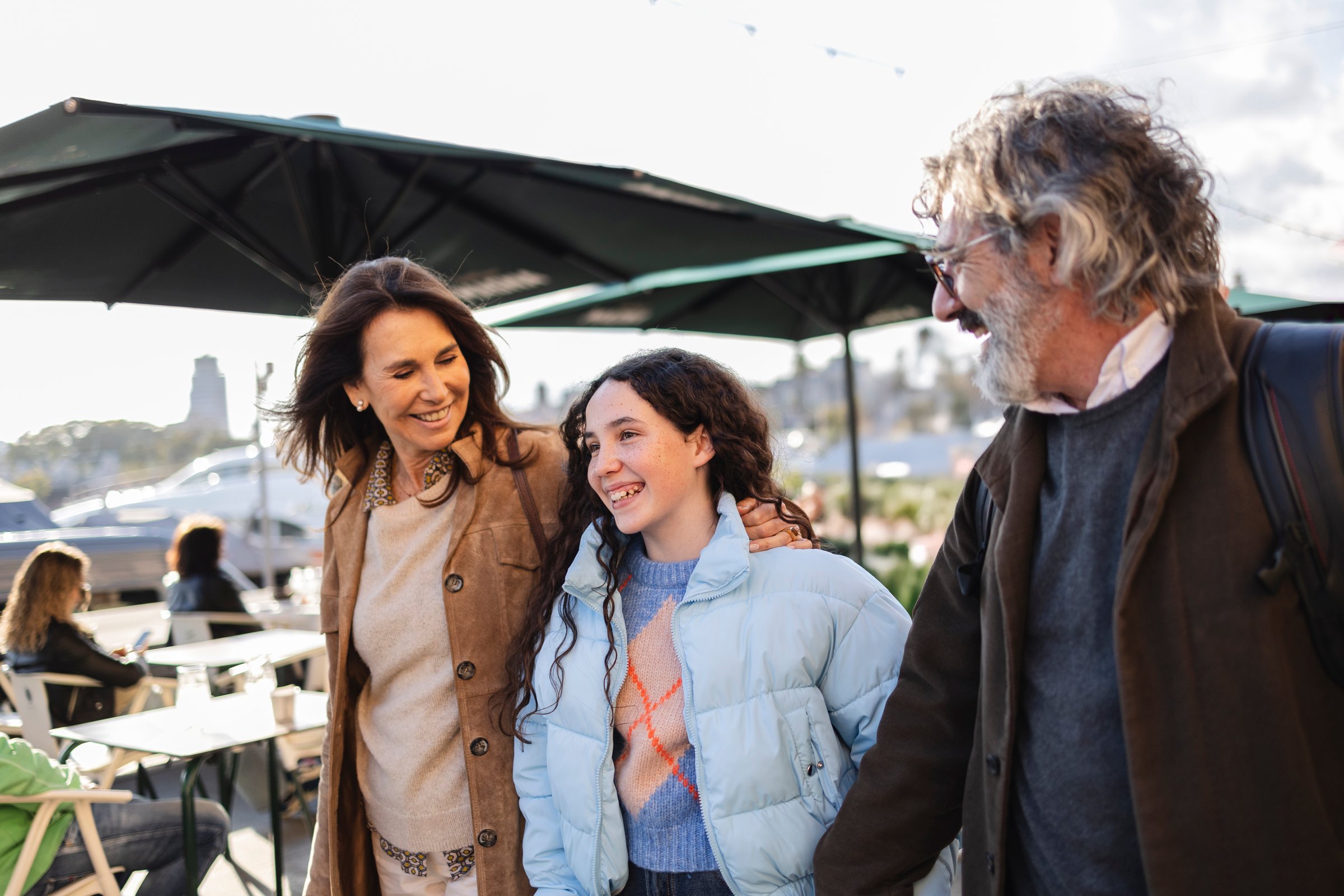 Sugarfree.space California family health conscious lifestyle - Happy family consisting of a mother, father, and daughter walking together outdoors in an urban environment