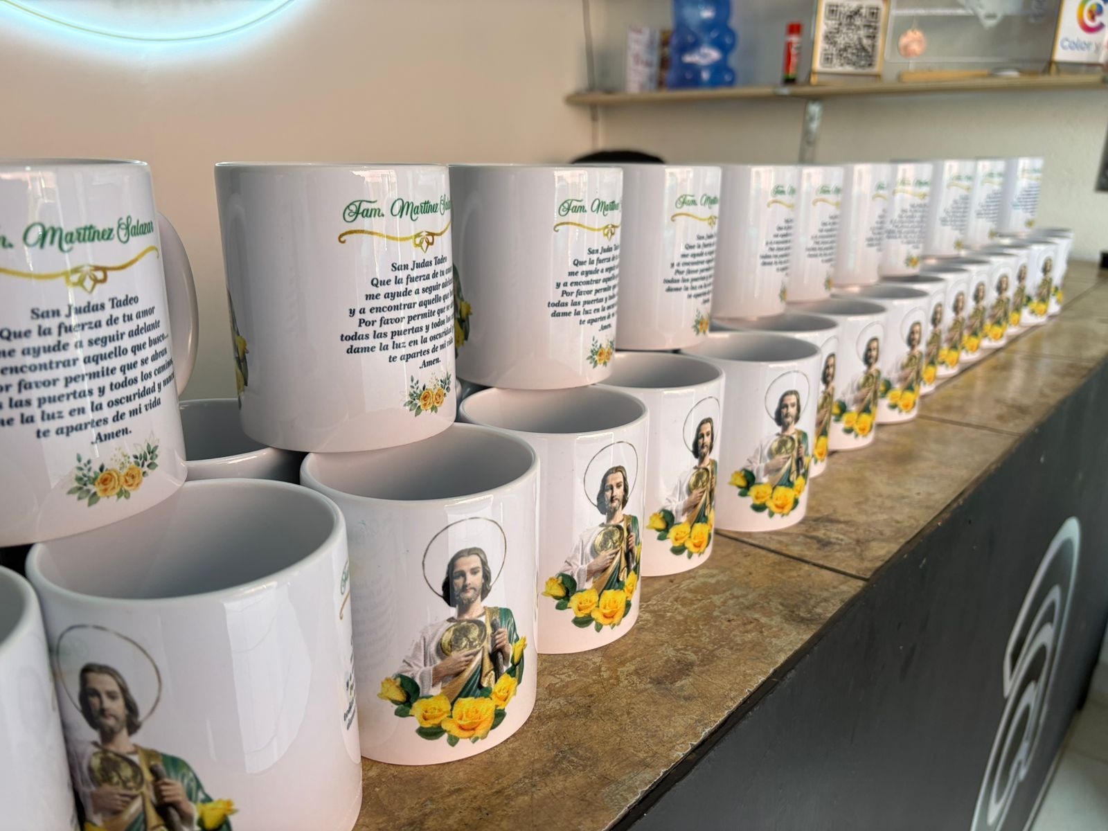 Pink and white ceramic mug with quotes on it displayed on storefront of supermarket to attract the buyer. Can be used for souvenir to drink coffee, tea, or other warm drinks