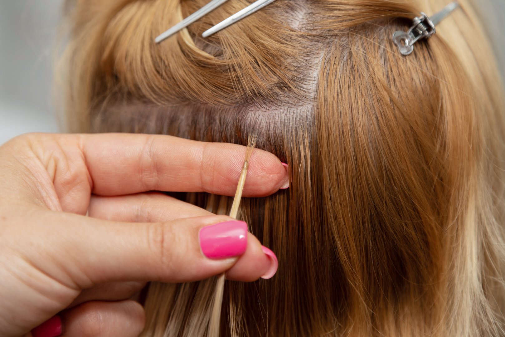 A strand of blonde hair extensions. Change of hairstyle. Beauty parlour. High quality photo