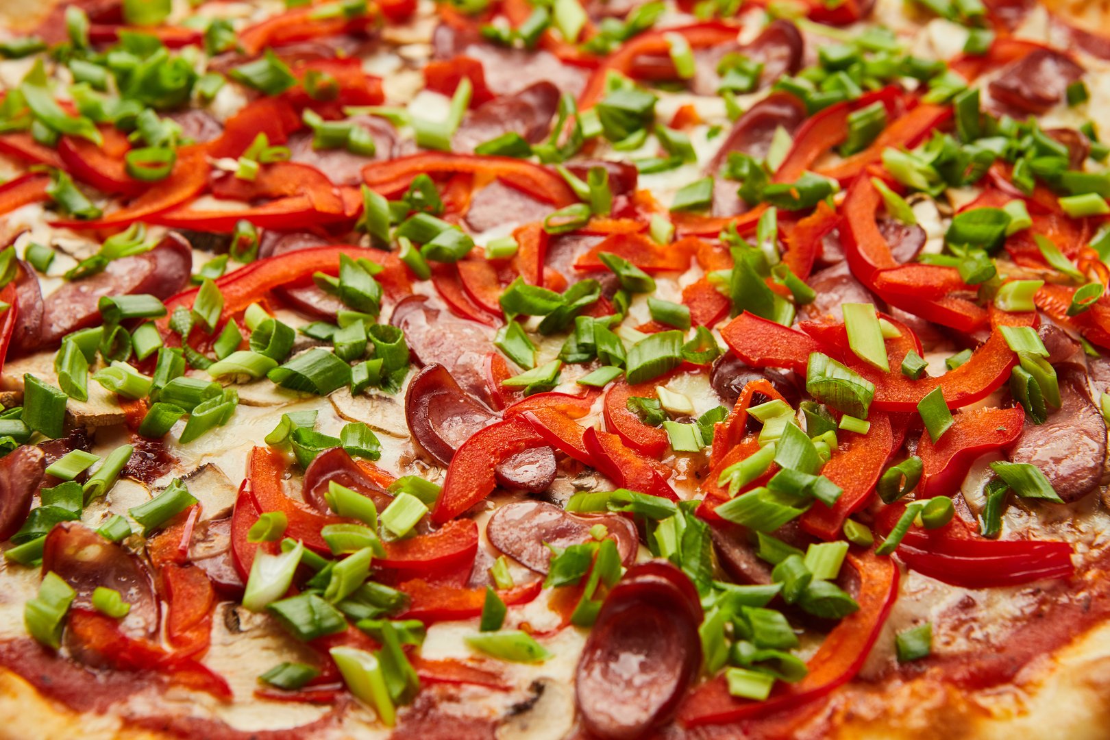 Pizza with ham, chorizo, jalapenos, and avocado