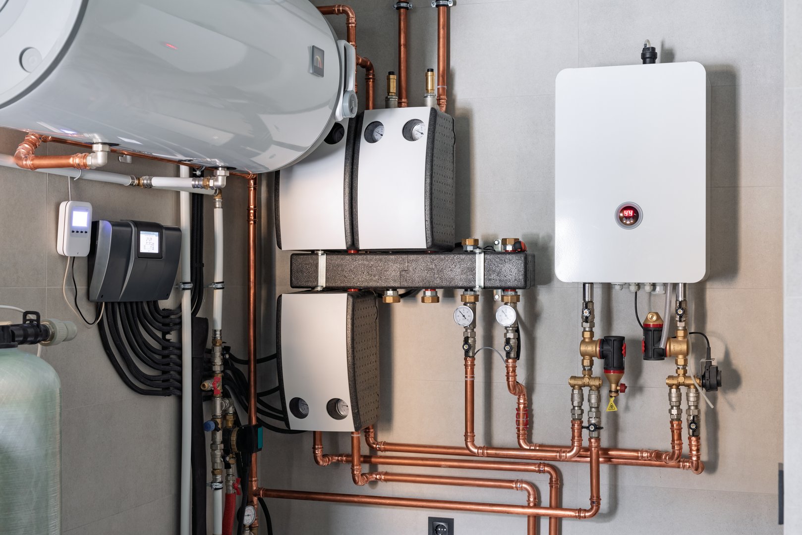 Wall installation of electric boiler device, valves, pumps, cooper tubing, water heater, automatic controller in a single family home