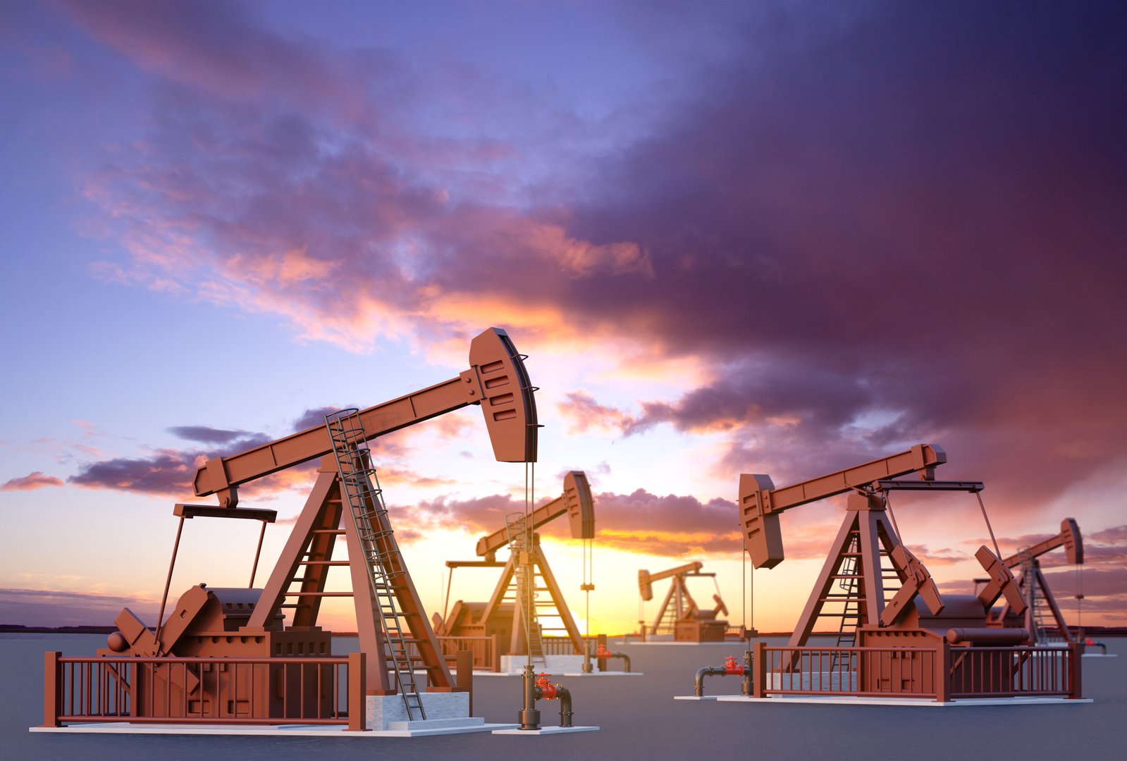 Oil well pumpjacks against the sunset. Oil industry concept