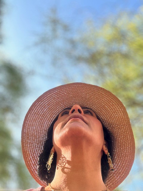 Sonal looking upward with inspiration, embodying your message of growth and possibility