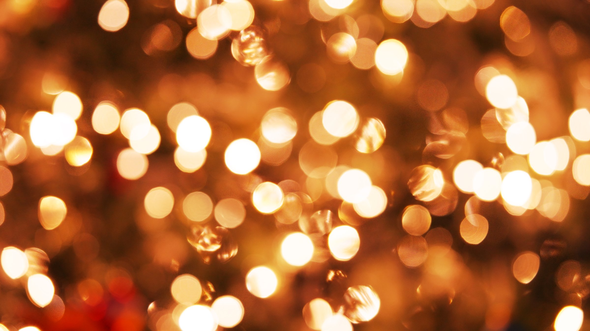 Christmas mood. Bright background of golden twinkling lights garland close up on Christmas tree. Glitter celebration. Happy New Year. Festival. Merry Christmas. Winter holidays. Noel