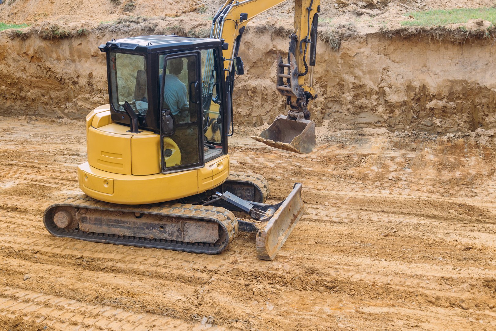 Tractor is leveling ground for pouring foundation of house