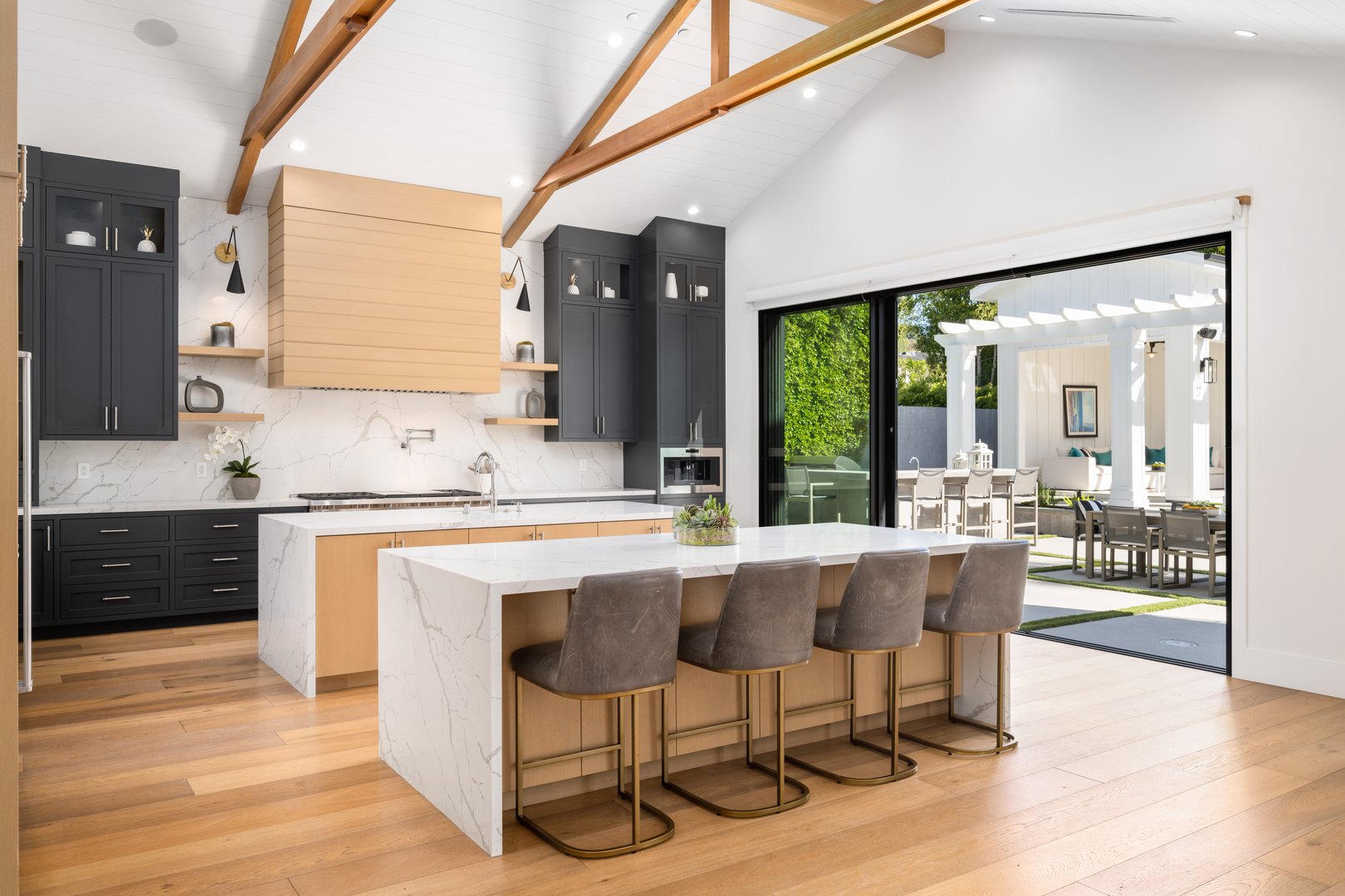 A spacious kitchen with black and white countertops and a white island