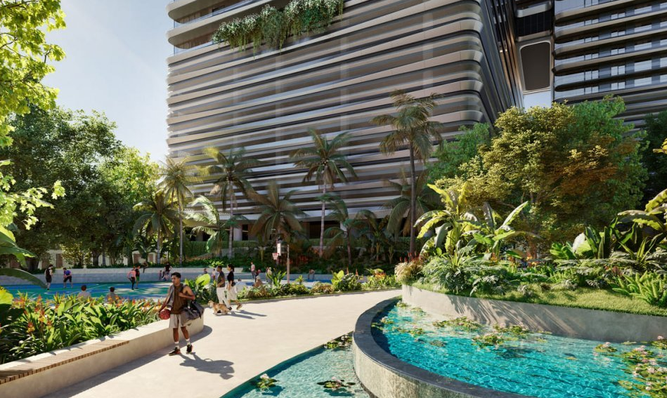 Modern building with curved facade, lush gardens, palm trees, and a walkway beside a decorative water feature.
