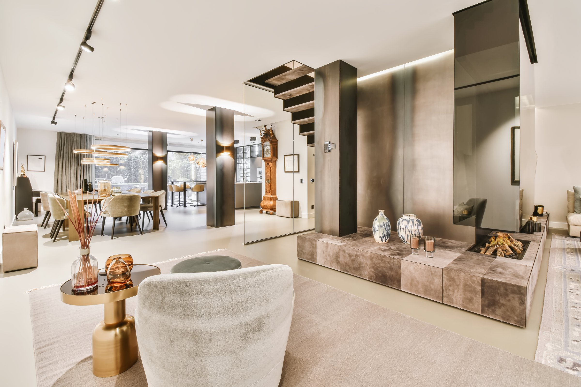An attractive large dining room with a black table and soft gray chairs