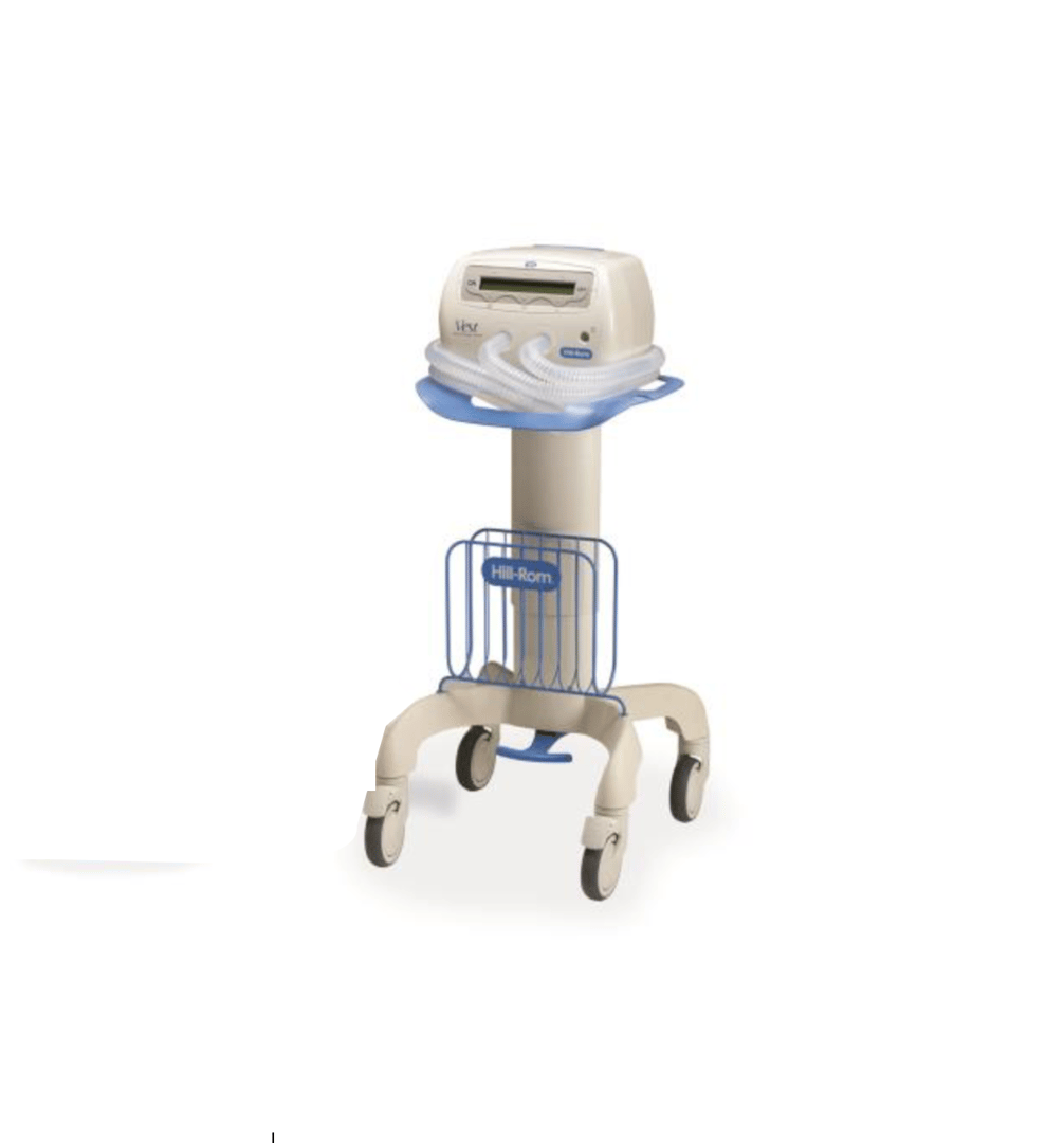 Medical equipment on a wheeled stand with a control unit and hoses. Blue and beige color scheme.