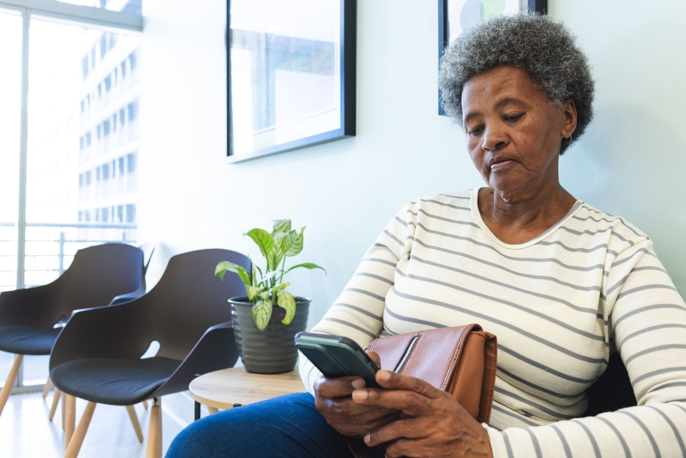 African American senior woman using smartphone