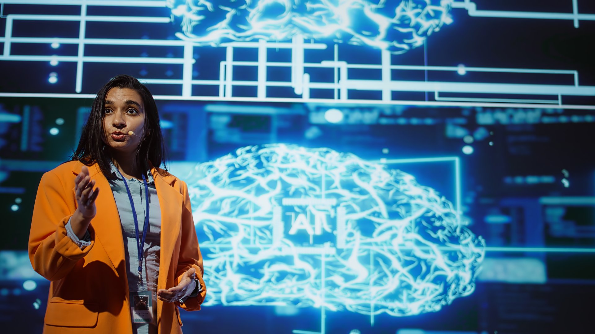 Speaker talking on stage in event bringing together leading experts, researchers, innovators and companies