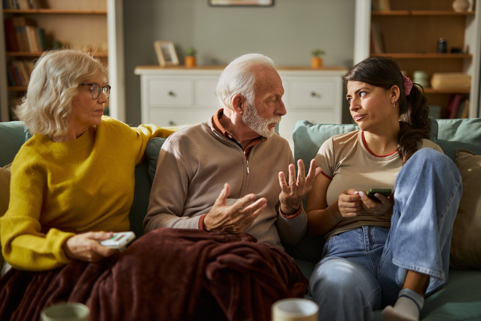 Adult child having conversation with elderly parent