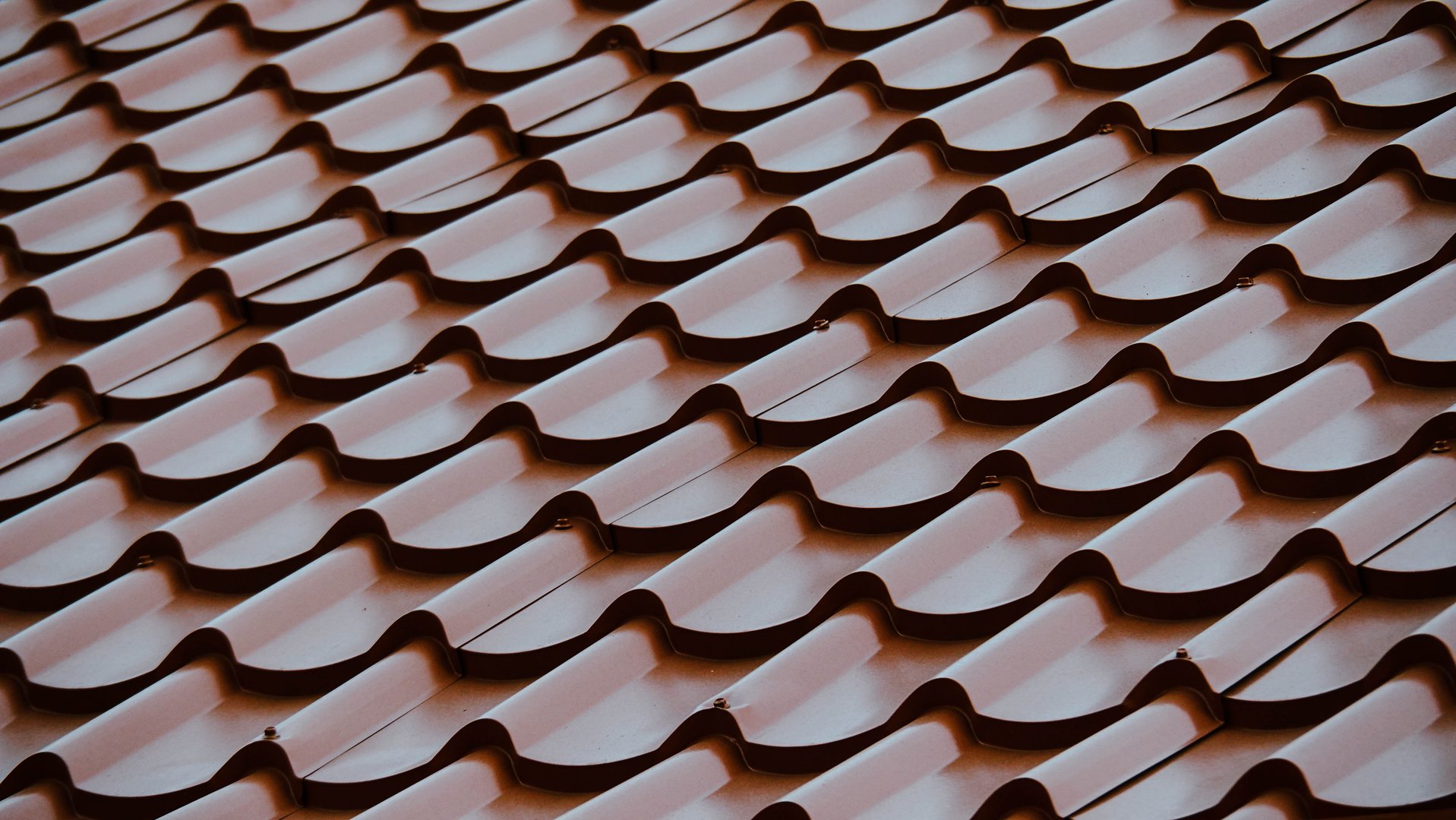 Close-up of Corrugated Metal Roof Tiles with Repeating Wave Pattern