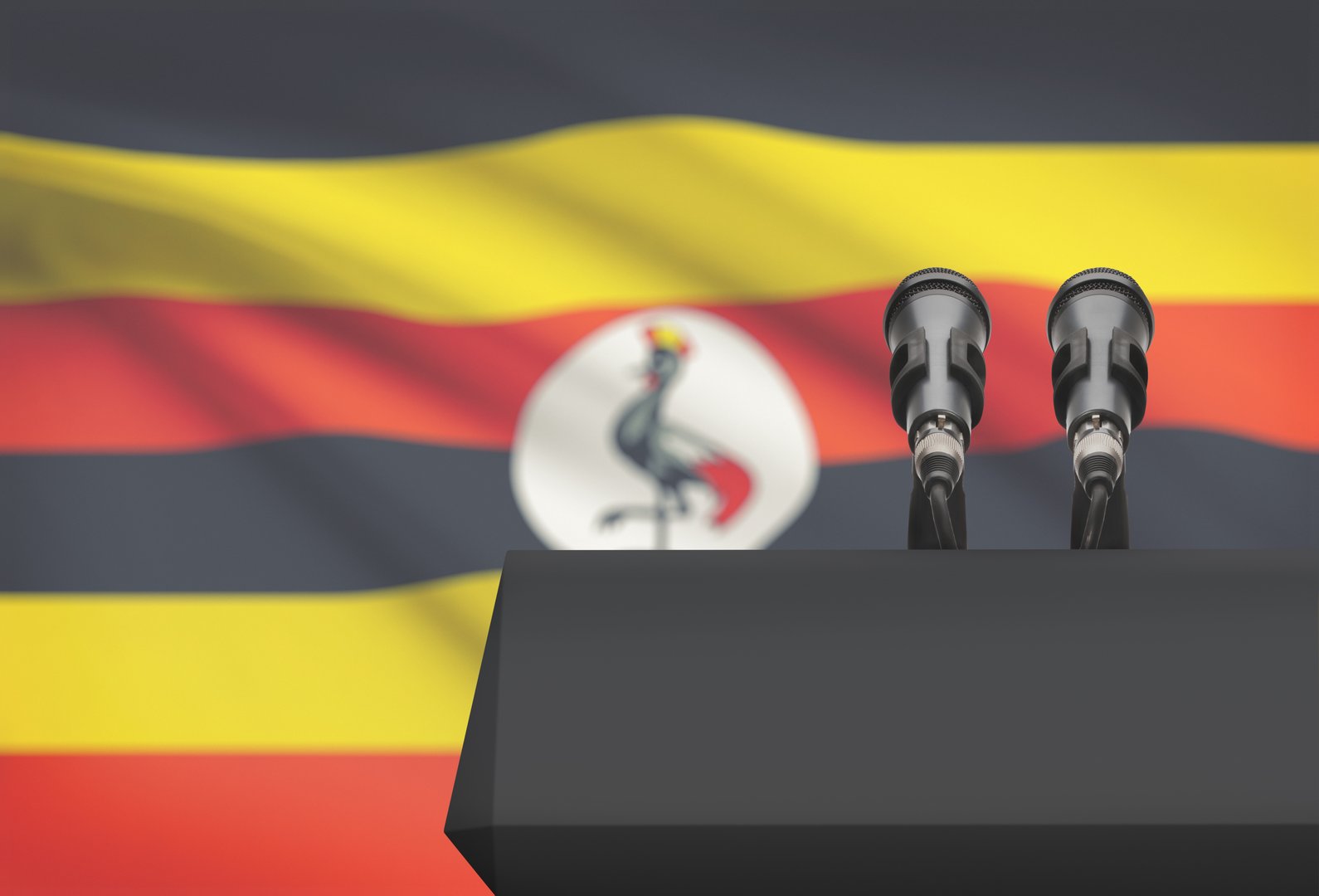 Pulpit and two microphones with a flag on background - Uganda