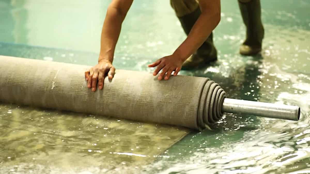 Rolling up rug during submersion hand wash process