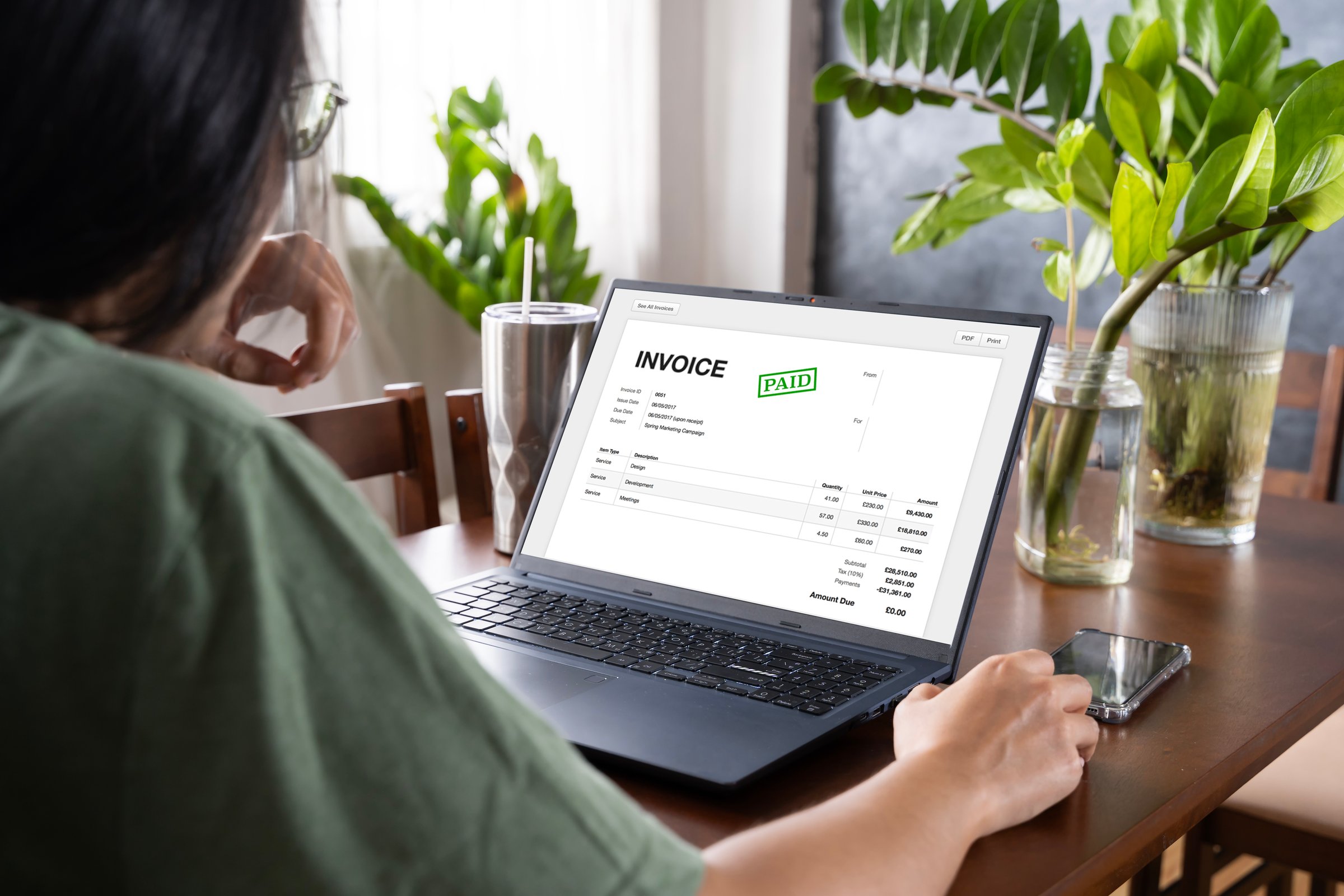 Businesswoman check company finances and earnings and budget. Online Digital E Invoice And Statements Software. Business woman calculating monthly expenses.