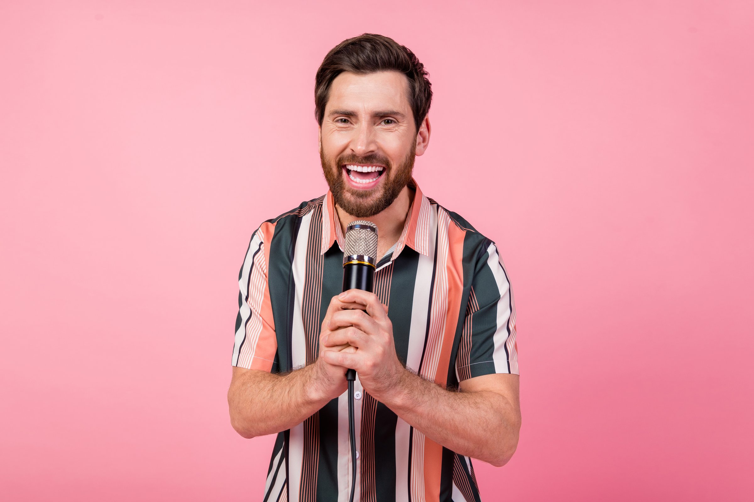 Photo of cheerful mature age brunet hair positive man with stubble comic telling funny stories isolated over pink color background.