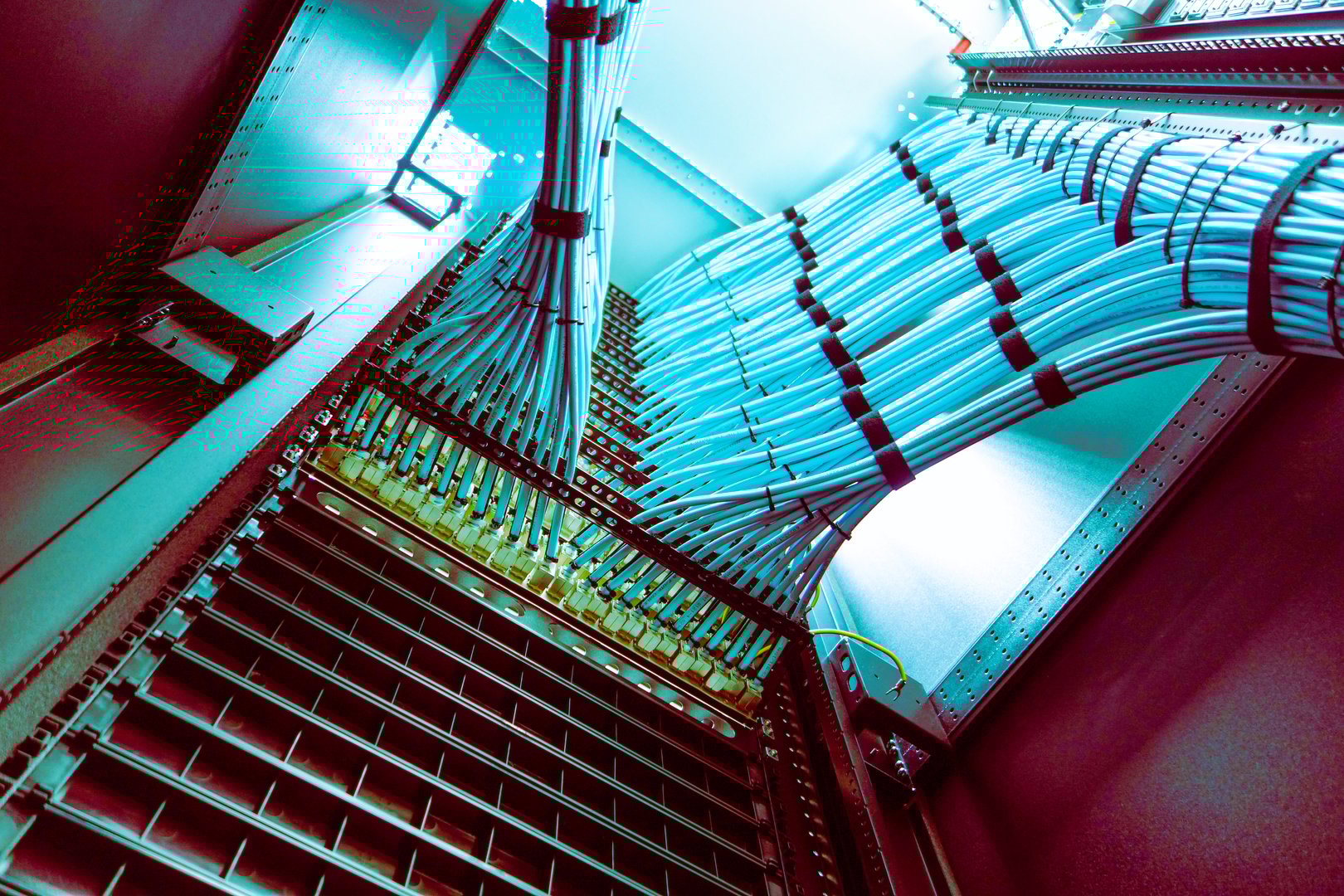 A vibrant perspective view of a server rack filled with neatly organized network cables, showcasing technology's role in data management and communication.
