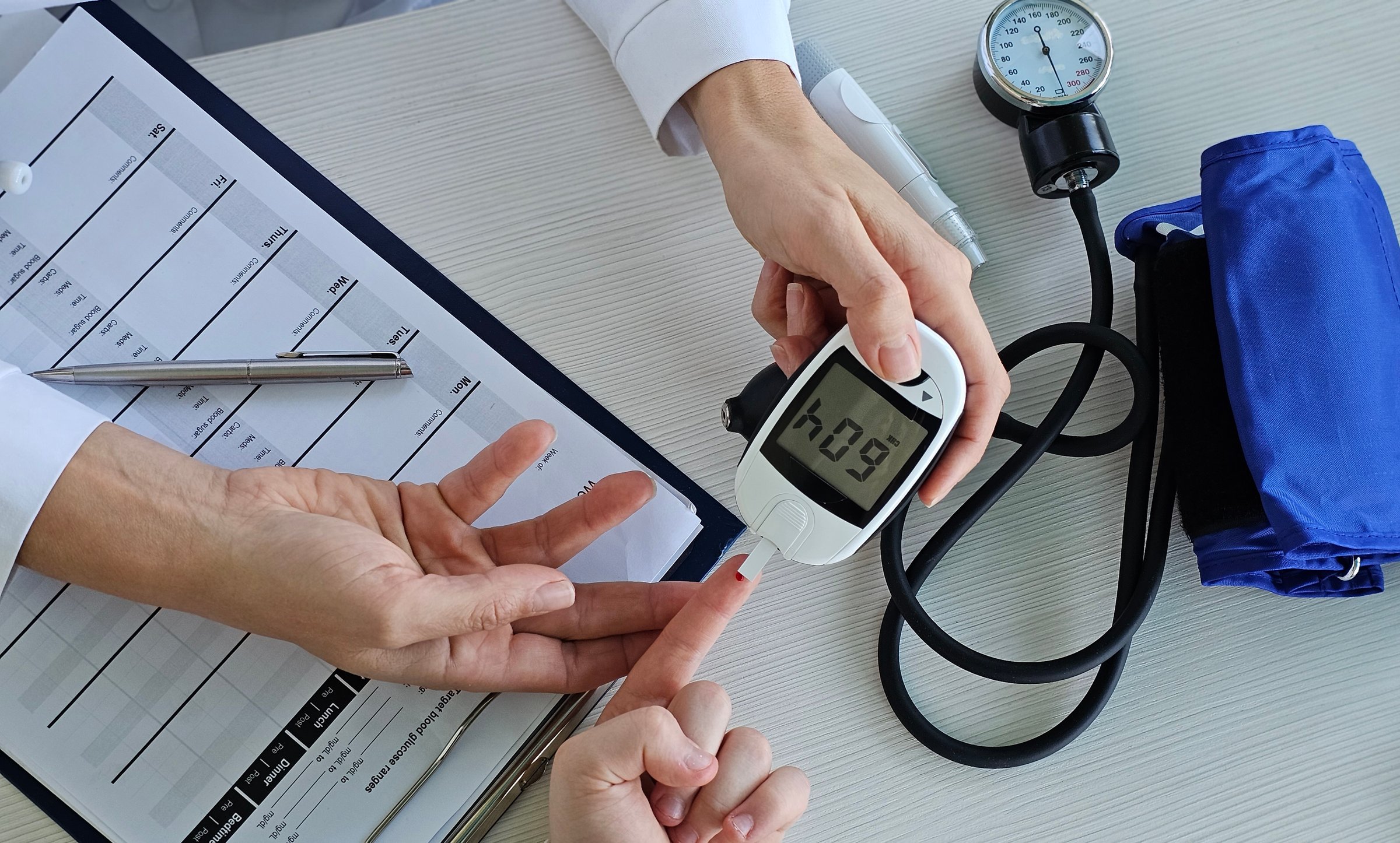 Blood pressure and blood sugar measurement during a medical checkup at a healthcare facility